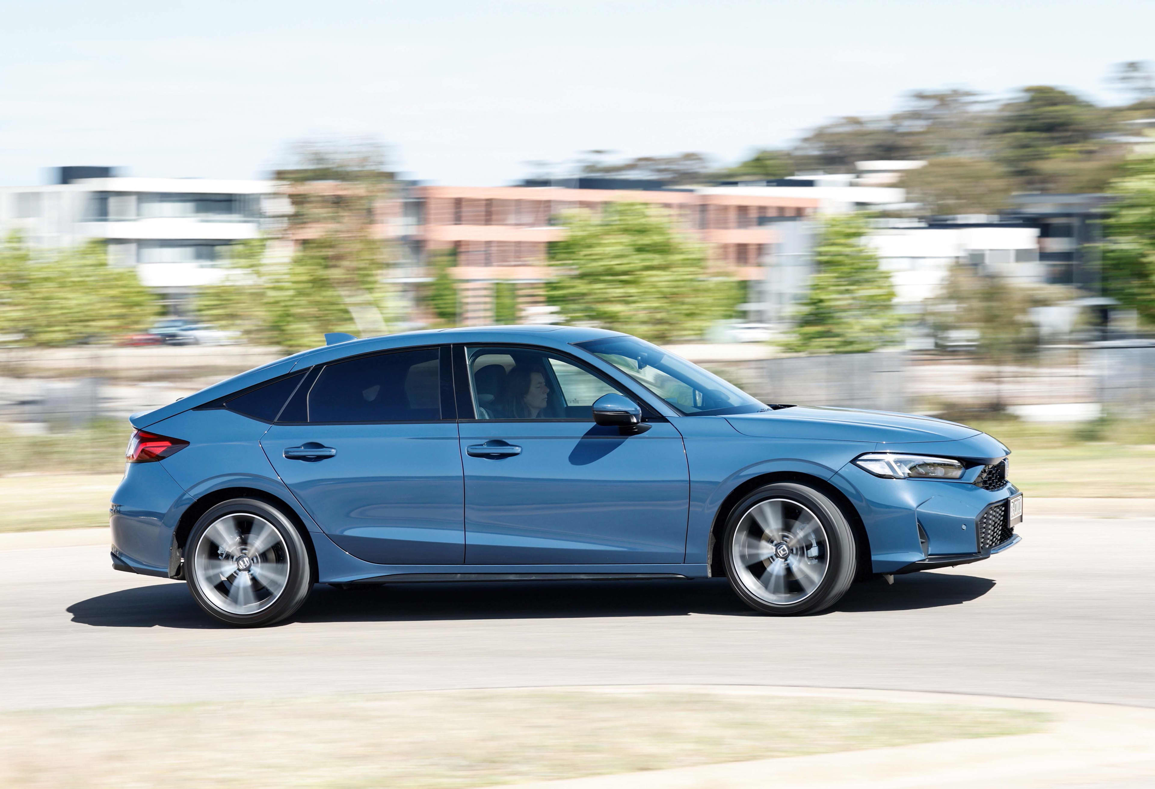 A blue Best Honda Civic driving on a suburban road