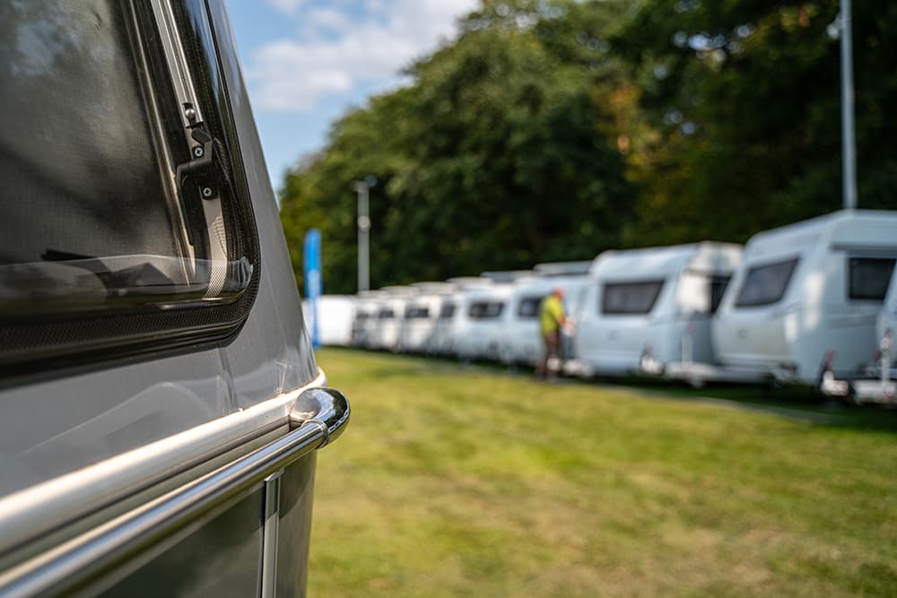 A row of new caravans on a grassed area