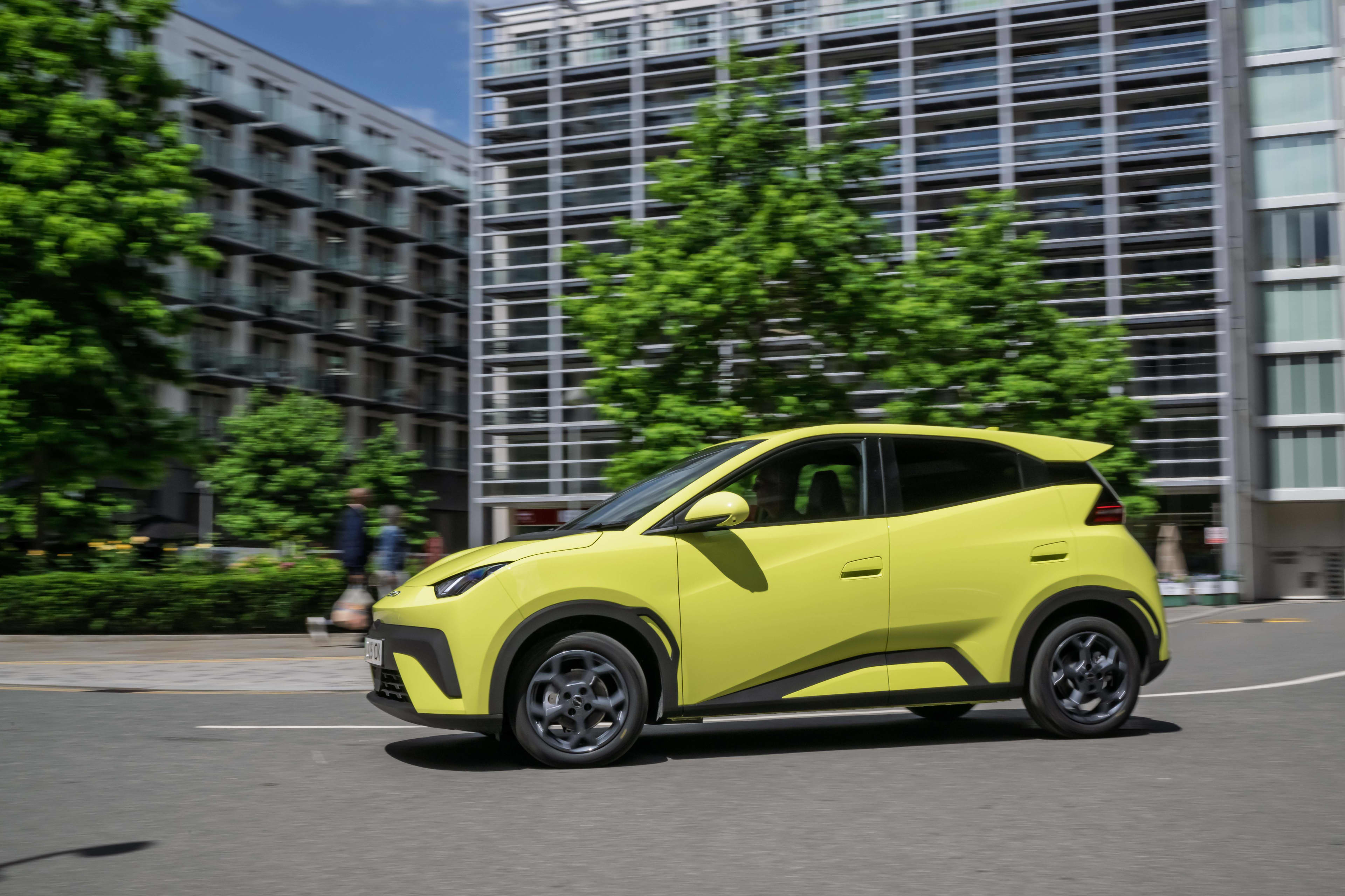 A lime green BYD Atto 1 on a city street