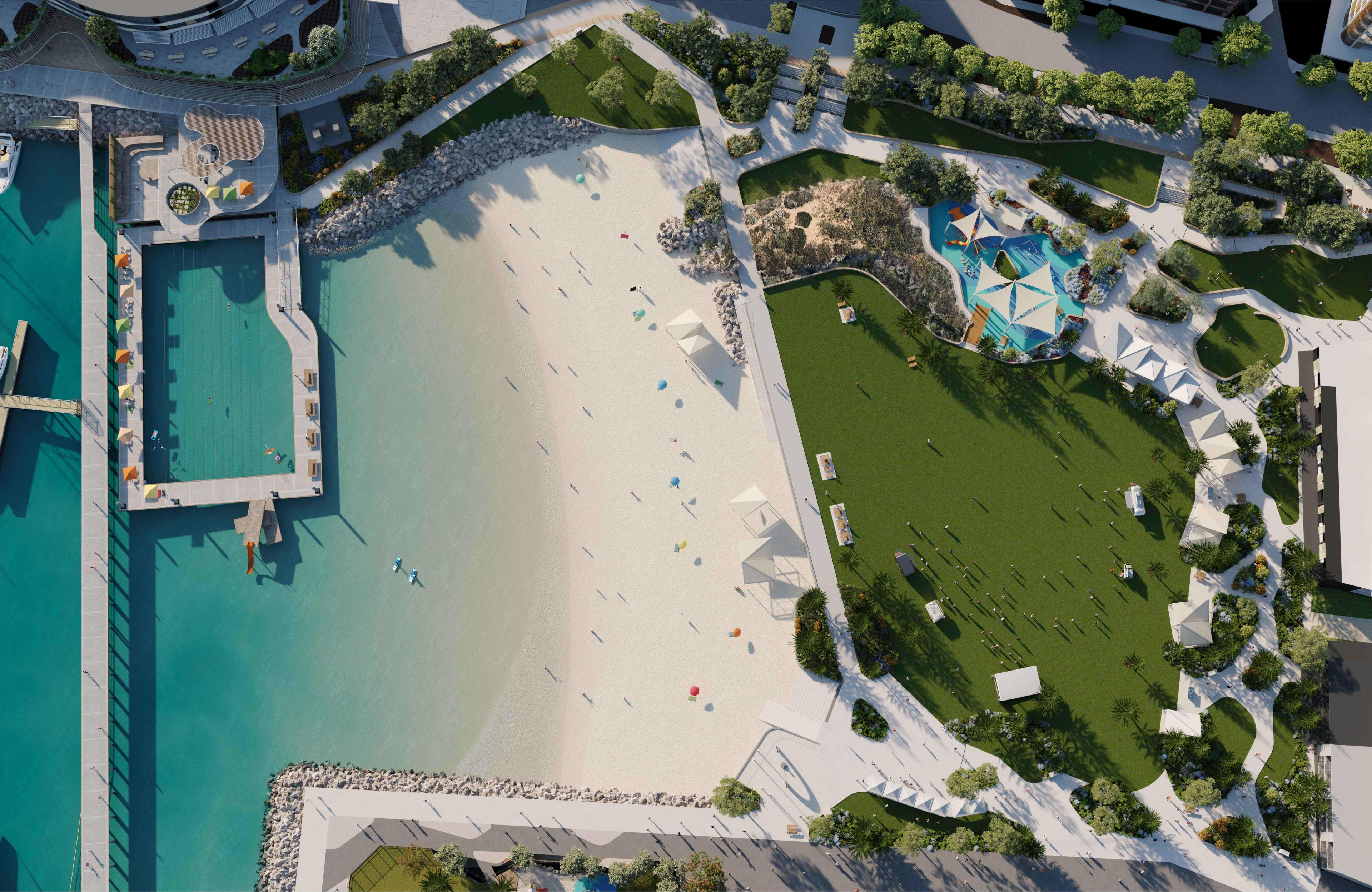 An aerial view of a man-made sheltered swimming area off the coast, with a large, grassed area fit with sheltered areas and a playground.