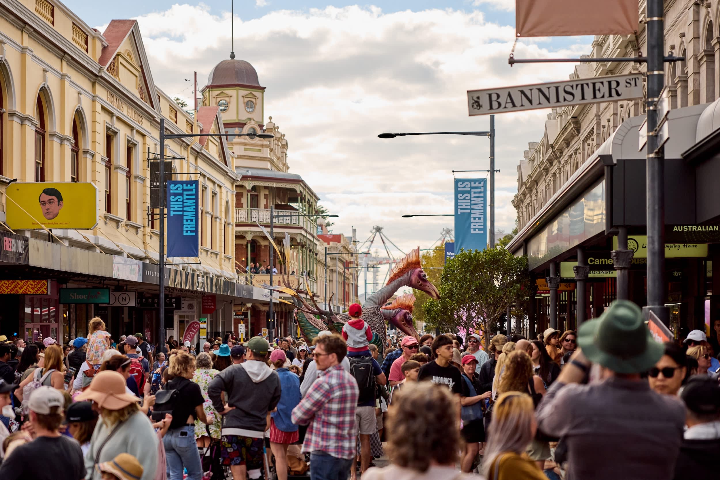 Bustling crowd on the main street of Fremantle for festival with people of all ages walking around.
