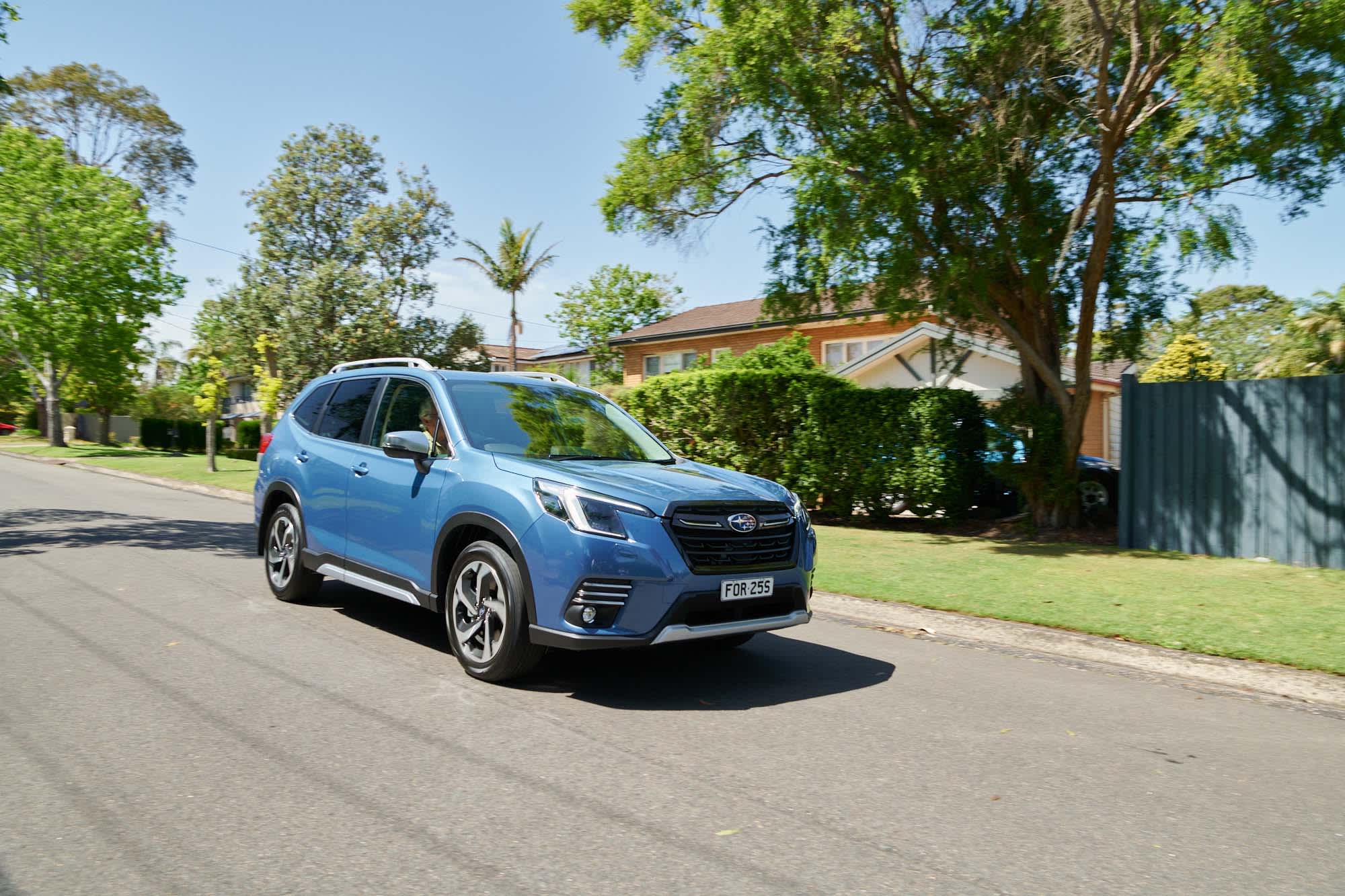 A blue Subaru Forester on a suburban street