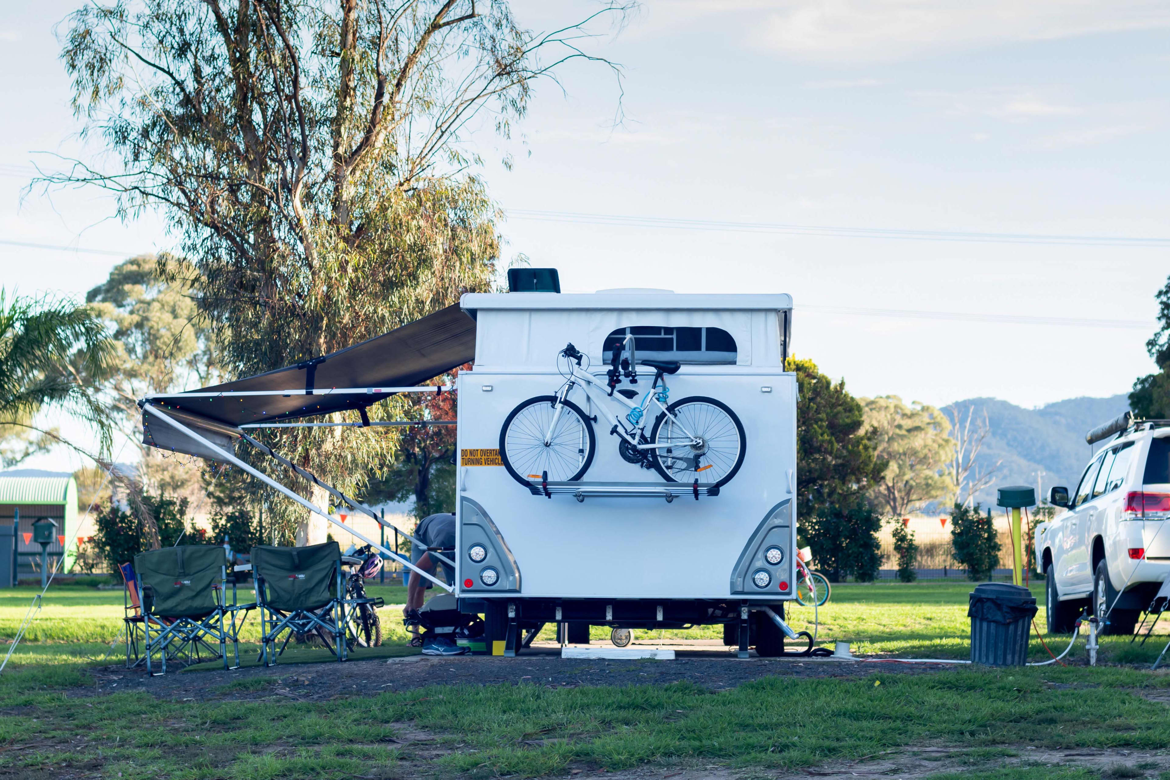 The rear view of a caravan with bike racks attached