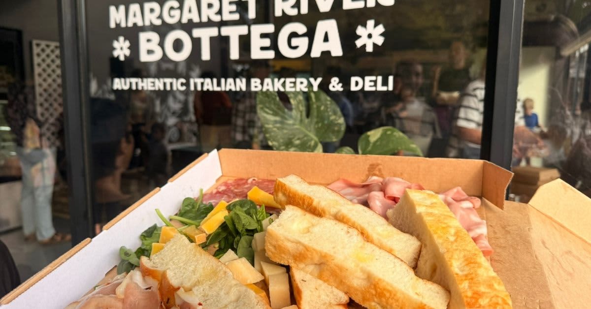 Platter of foccacia, ham and cheese in front of sign that reads Margaret River Bottega.