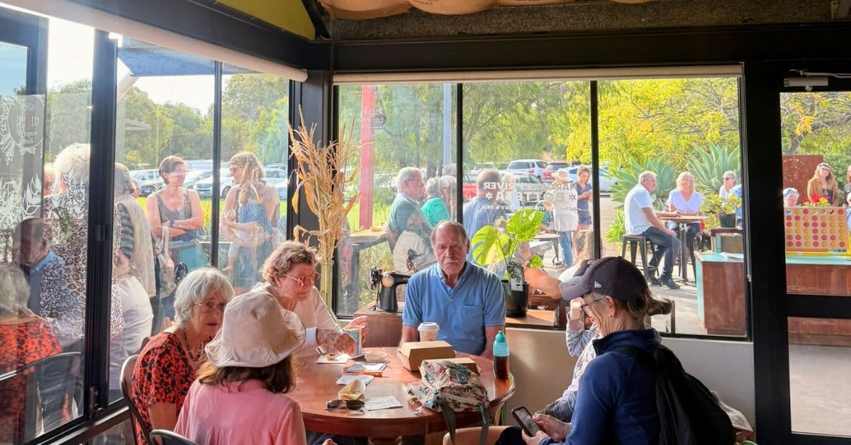 Group of people sitting in cafe.