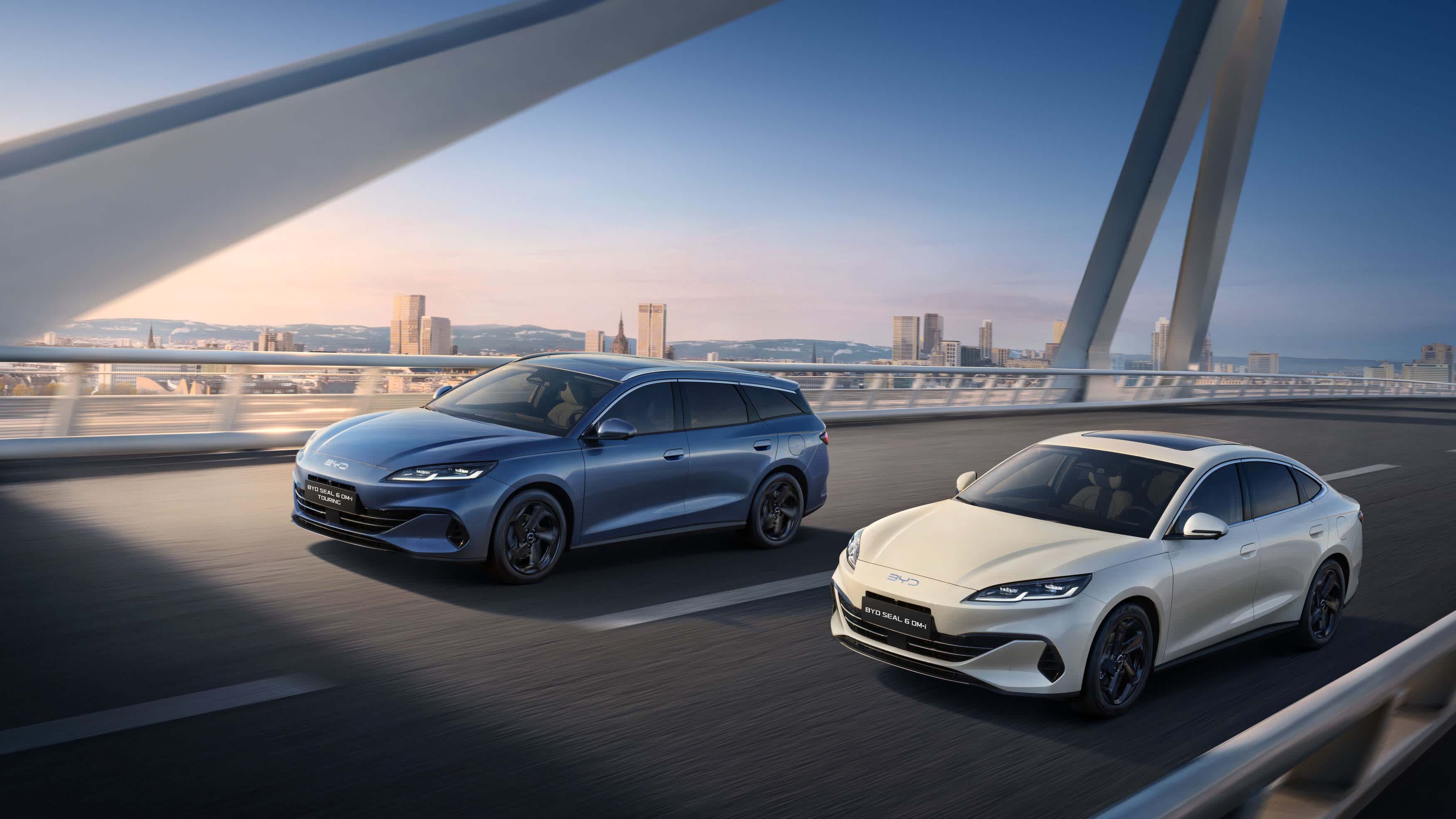 Two BYD SEAL 6 EVs on a city highway