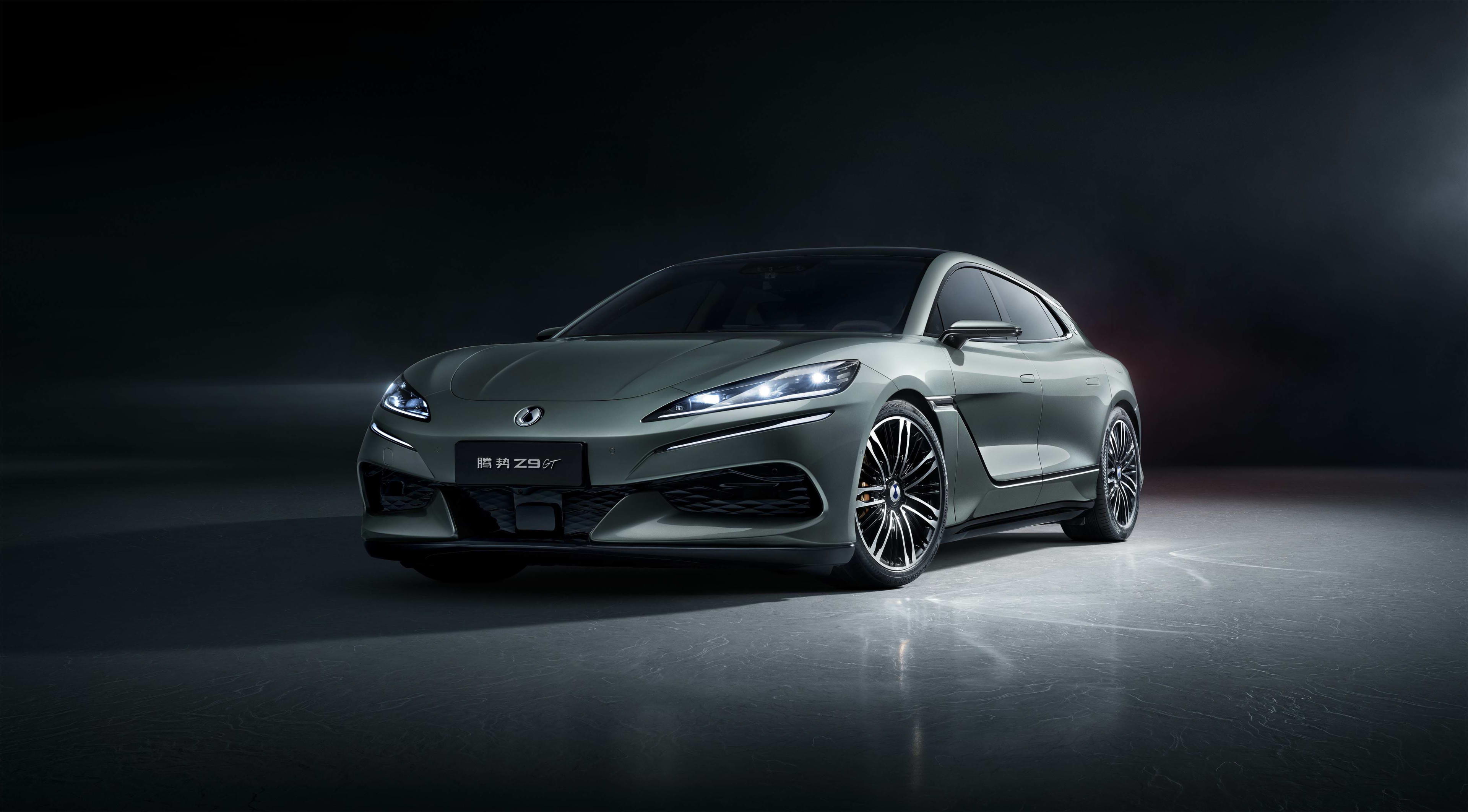 A silver DENZA Z9 GT in a dark-lit studio