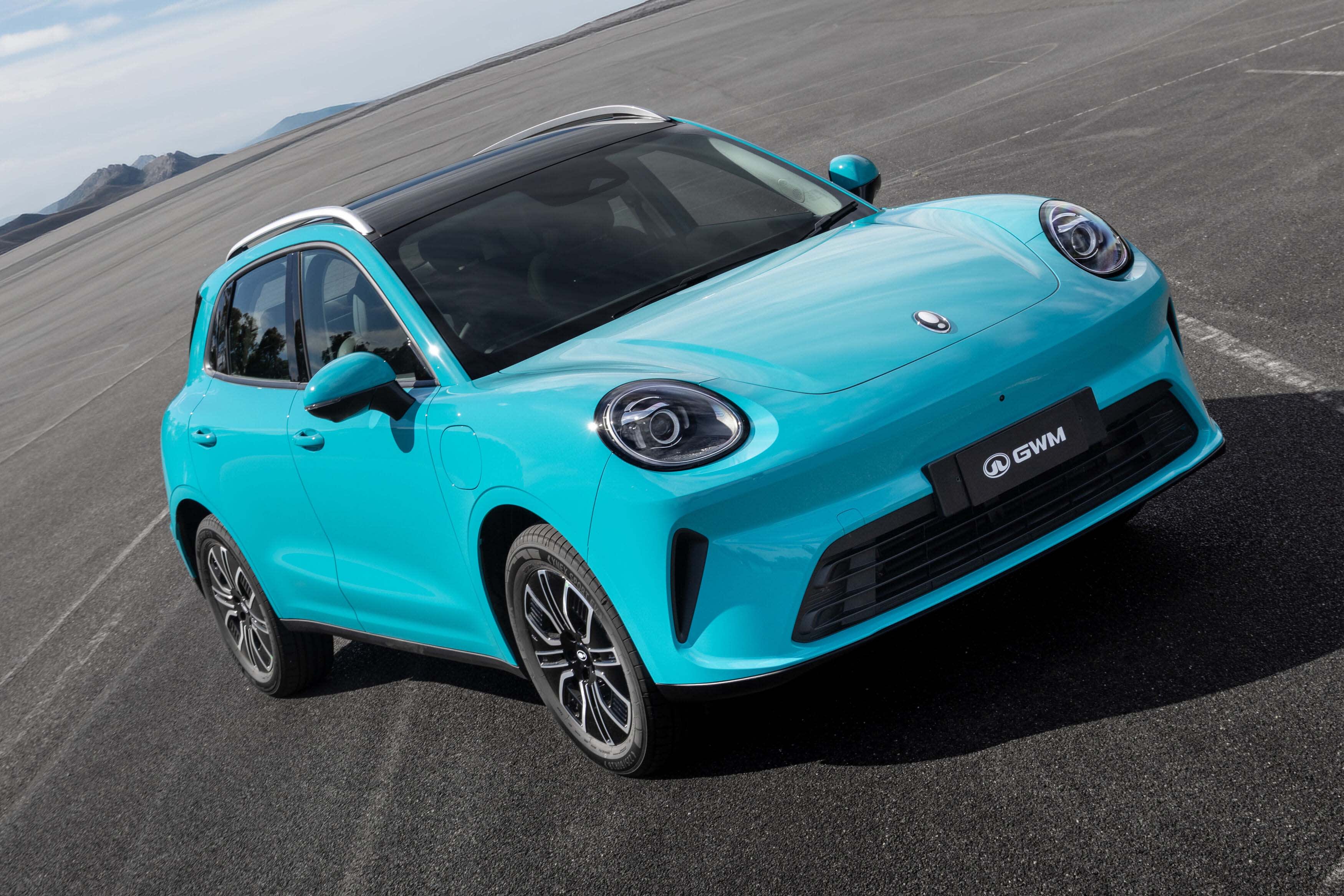 A bright blue GWM Ora 5 SUV on  a tarmac