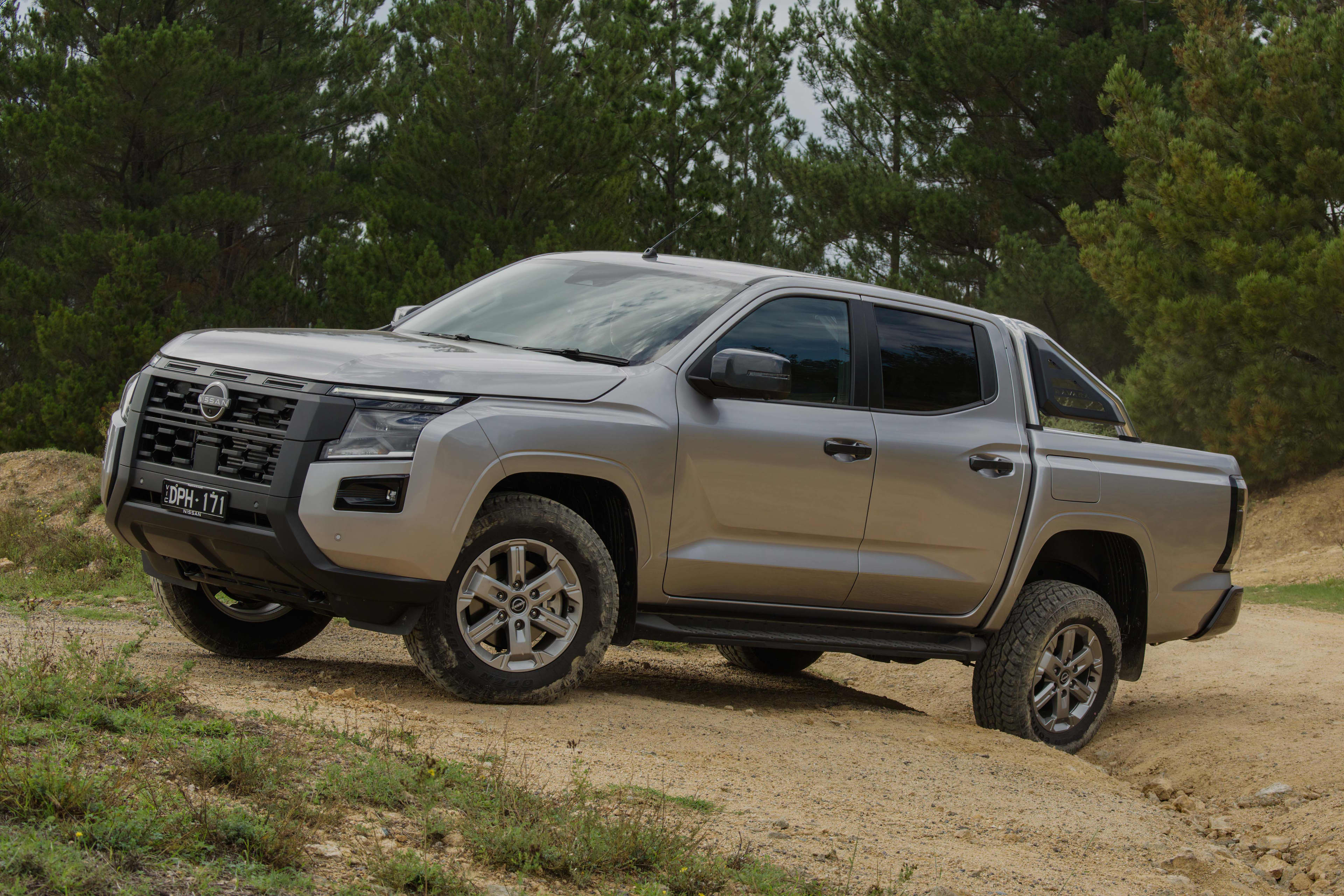 A grey Nissan Navara ST Dual cab ute driving on bumpy dirt track