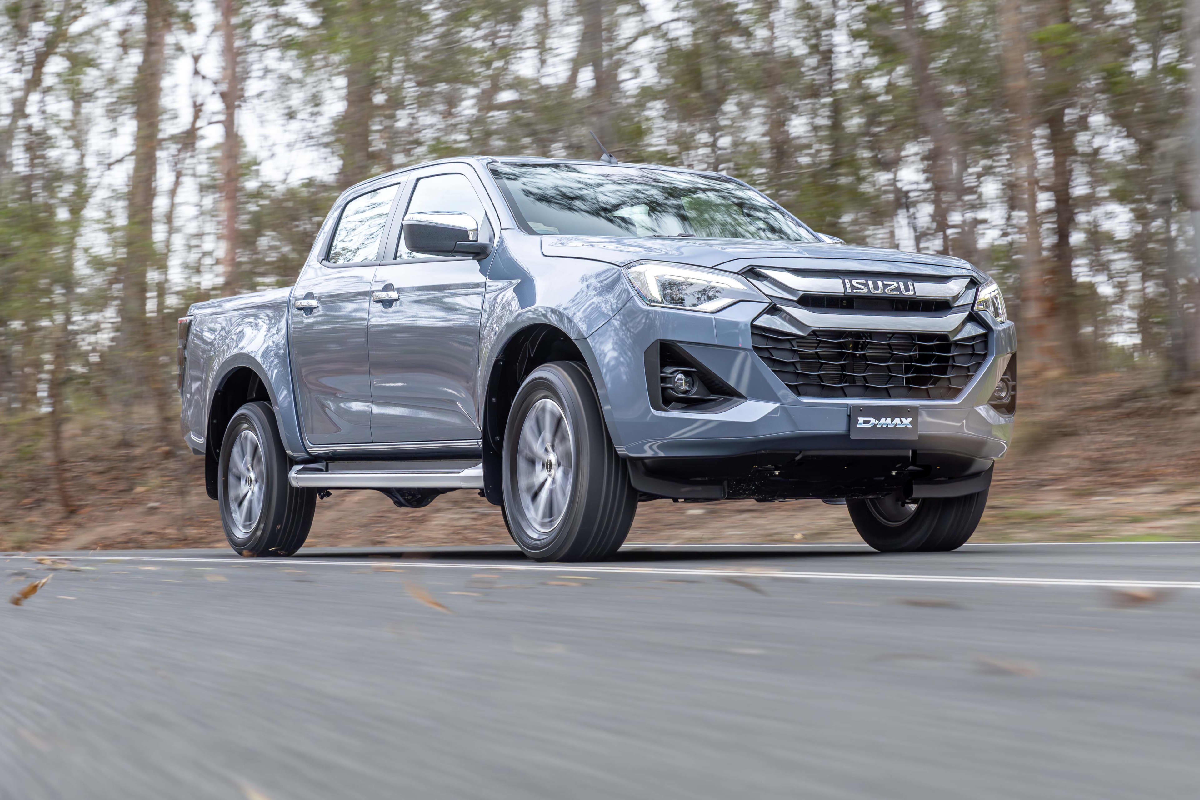 A grey Isuzu D-Max 2.2L driving on a country road