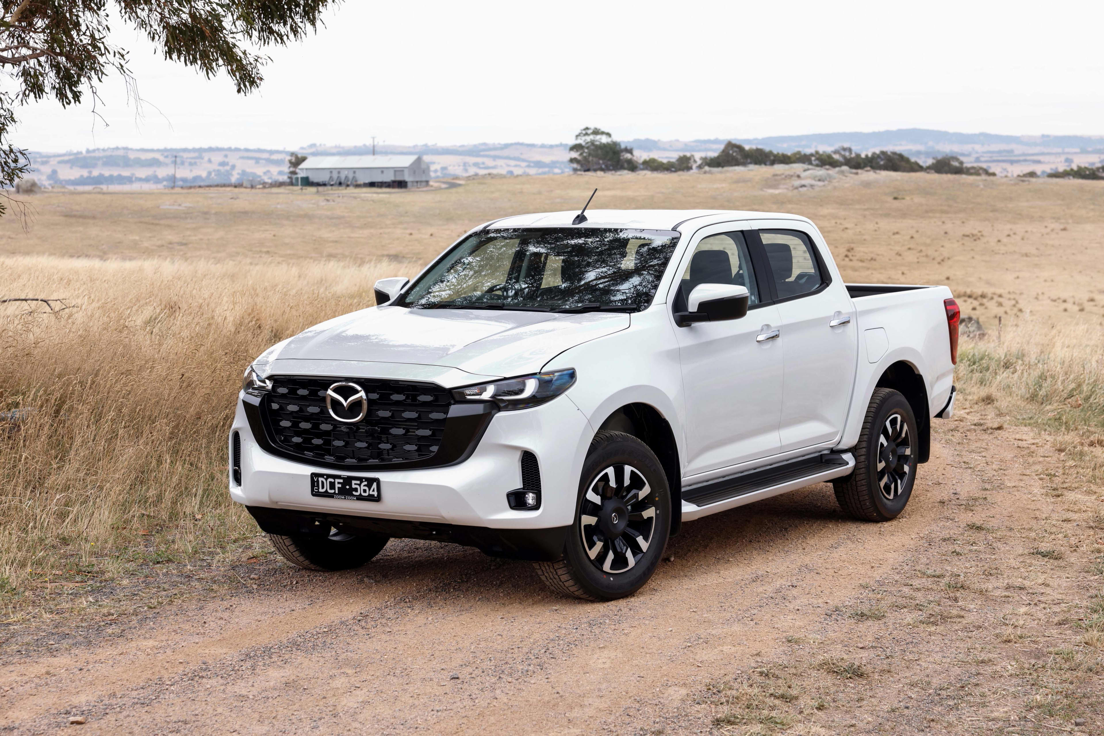 A white Mazda BT-50 3.0L parked on a dirt track