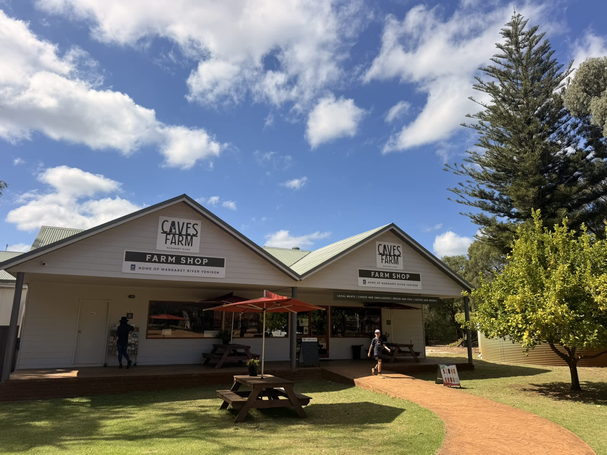 A farm shop with outdoor seating and verandah