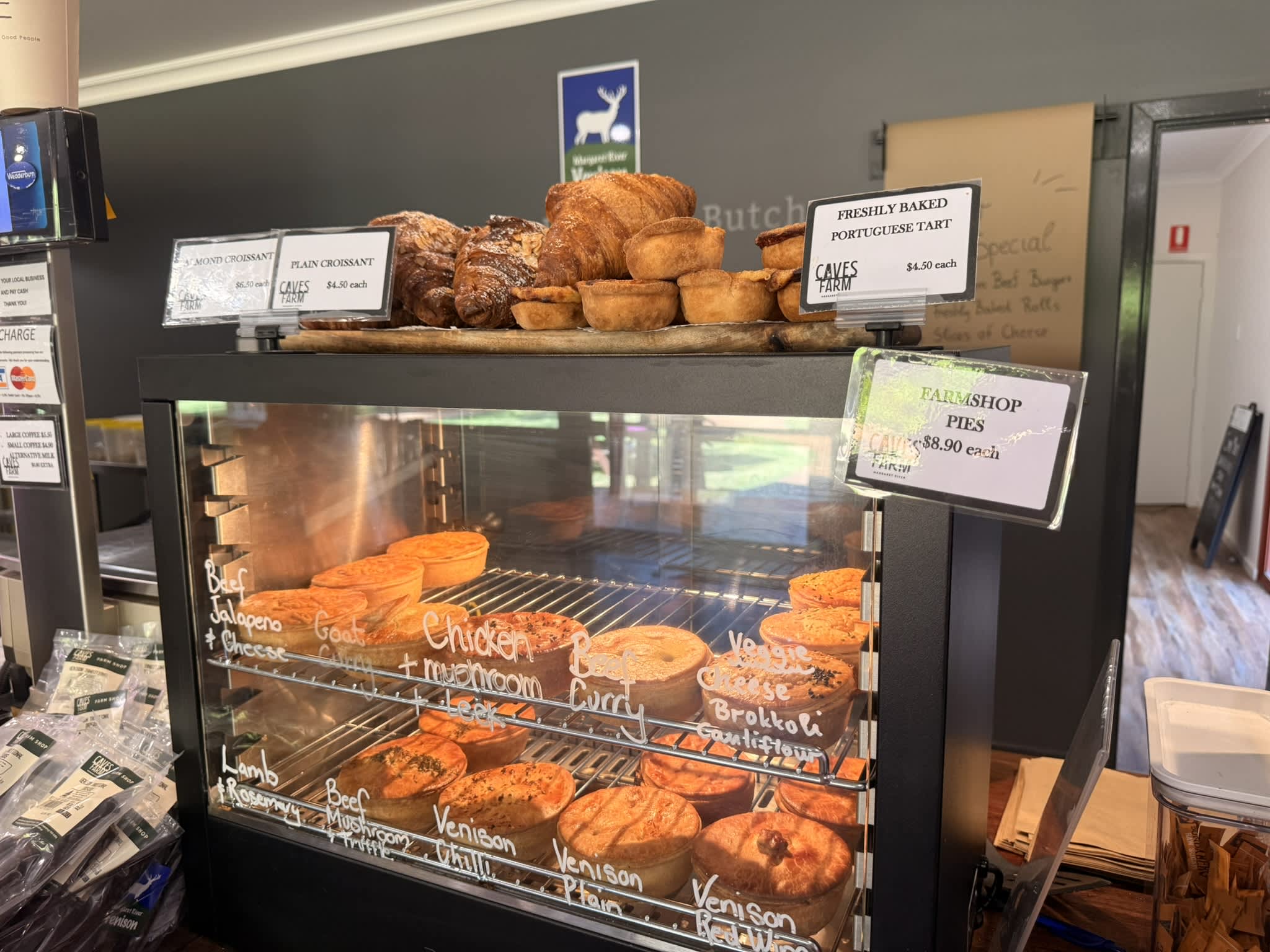 Gourmet hot pies in oven with pastries and portugese tarts stacked on top