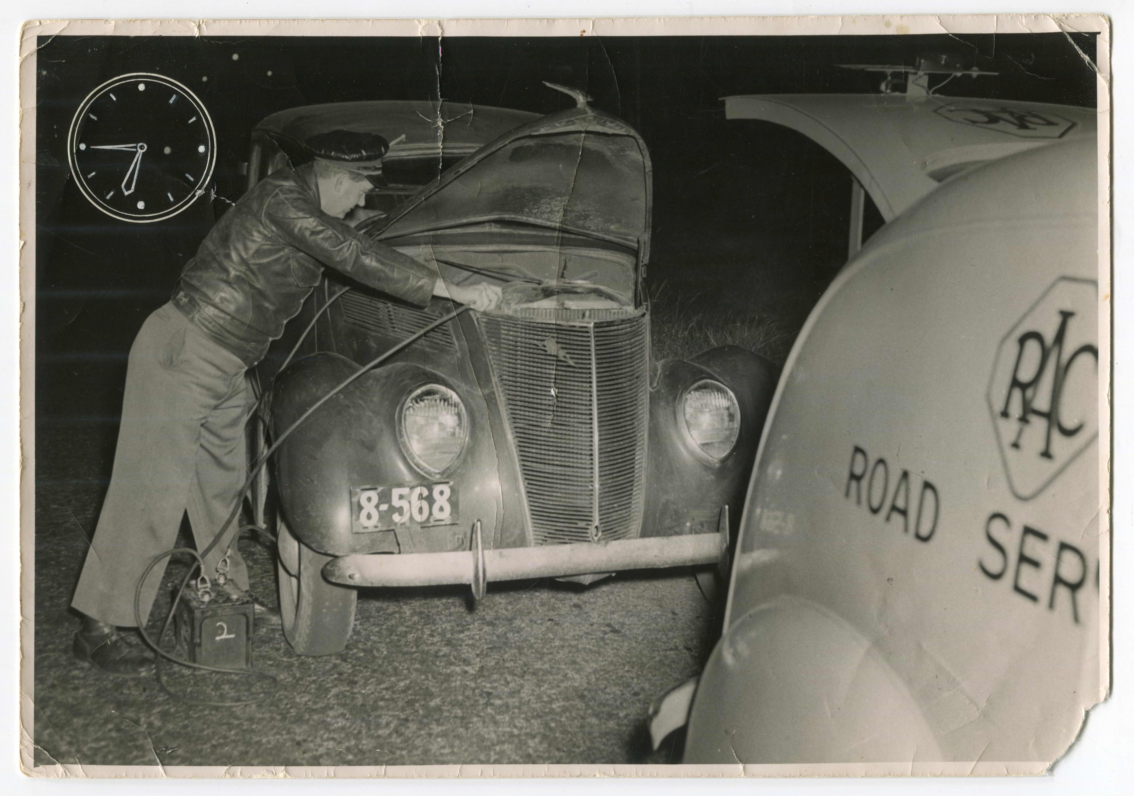 An RAC Roadside Assistance patrol charges a car battery in 1934