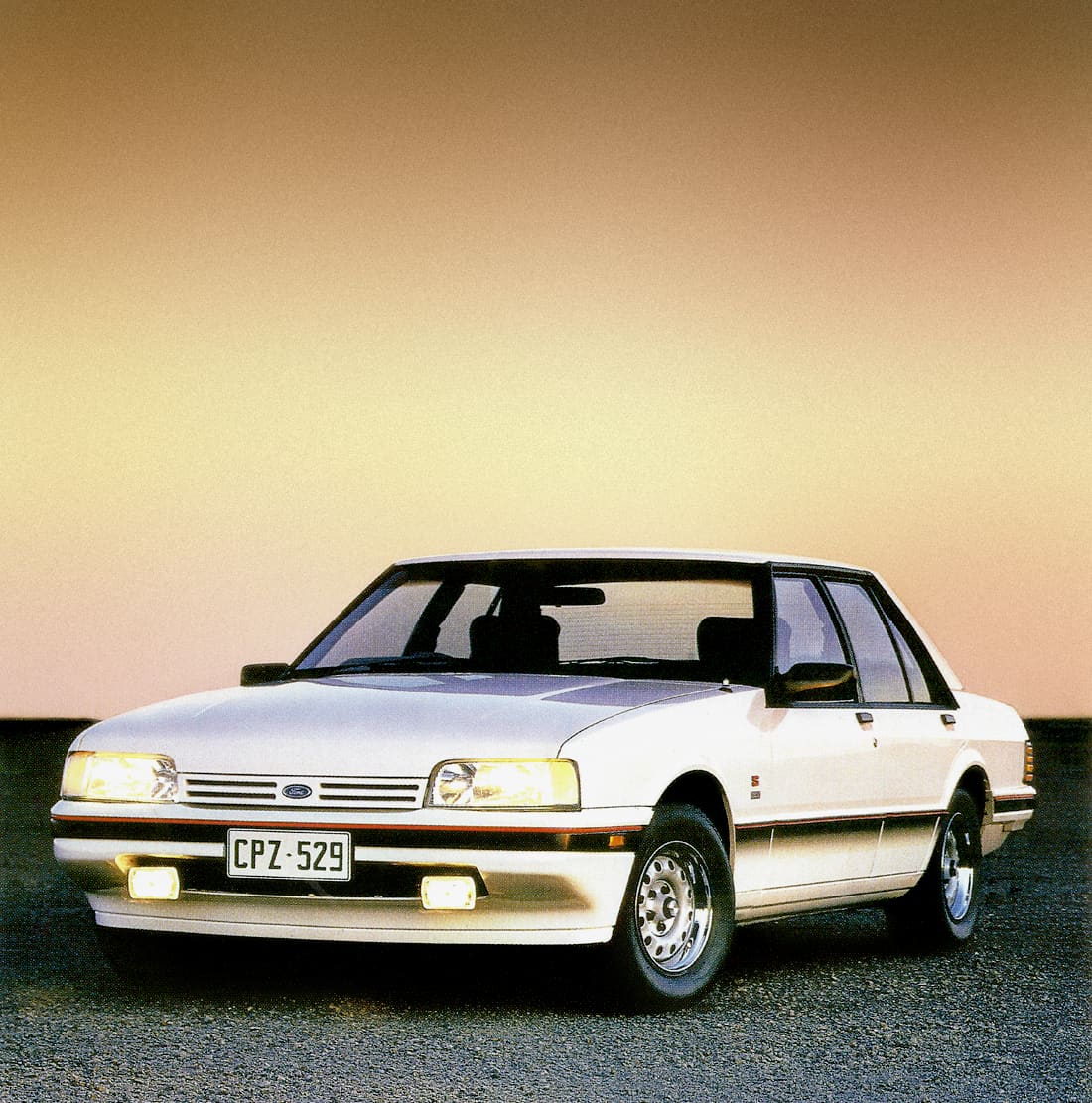 A white 1986 Ford XF Falcon parked on a tarmac