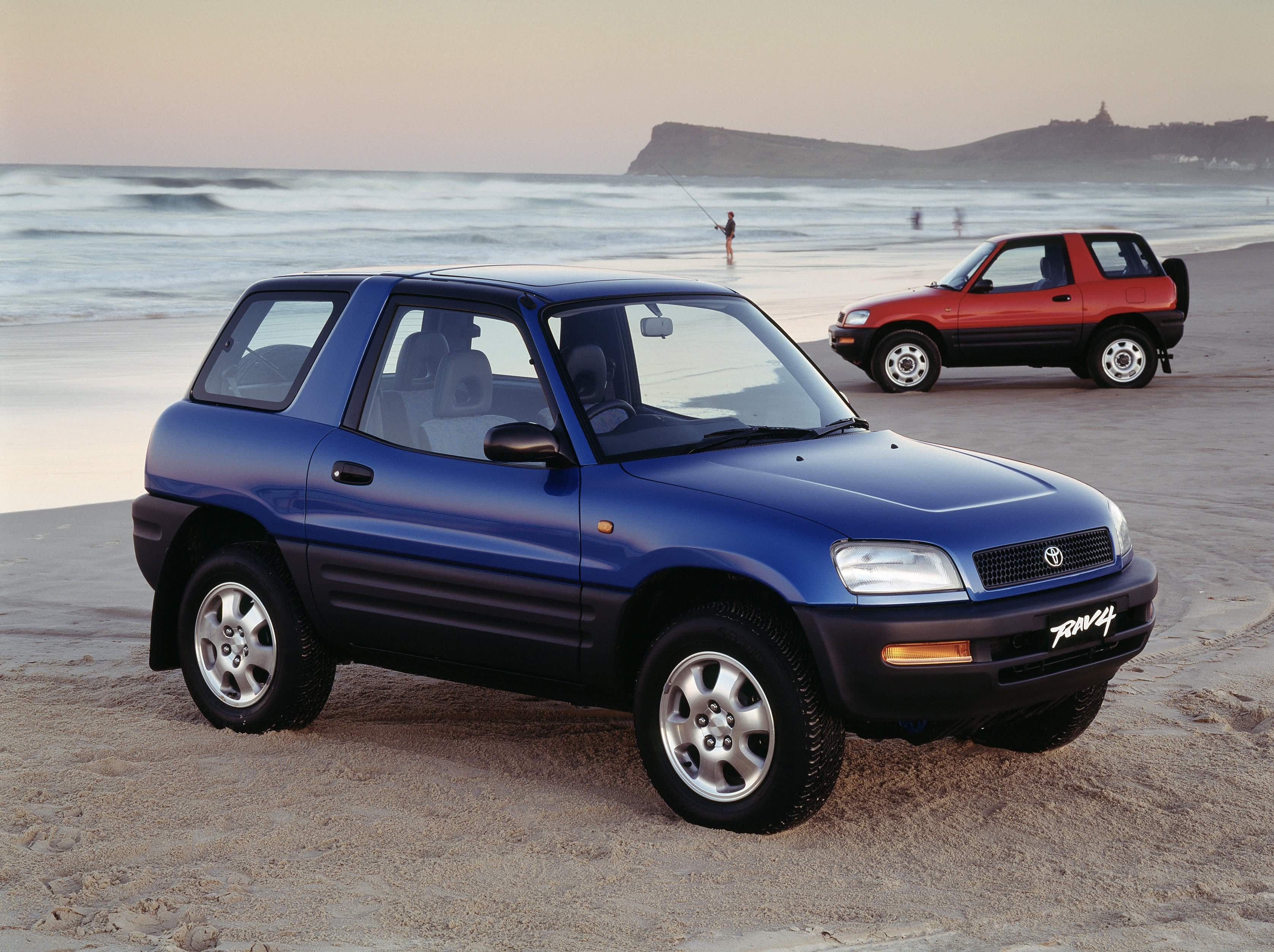A blue 1994 Toyota RAV4 parked on a beach