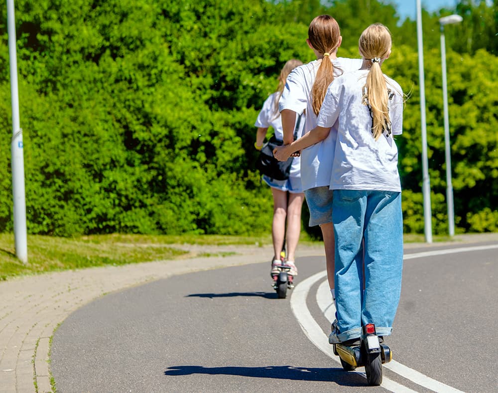 Children riding escooters without helmets