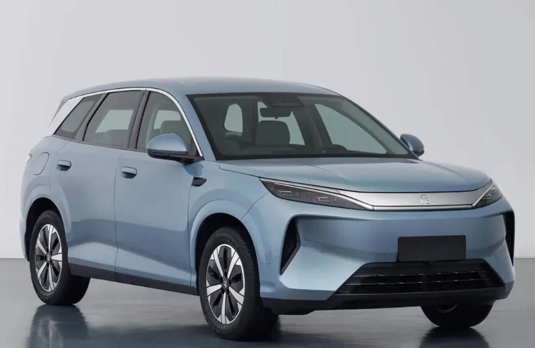 A blue BYD Atto 3 in a studio setting