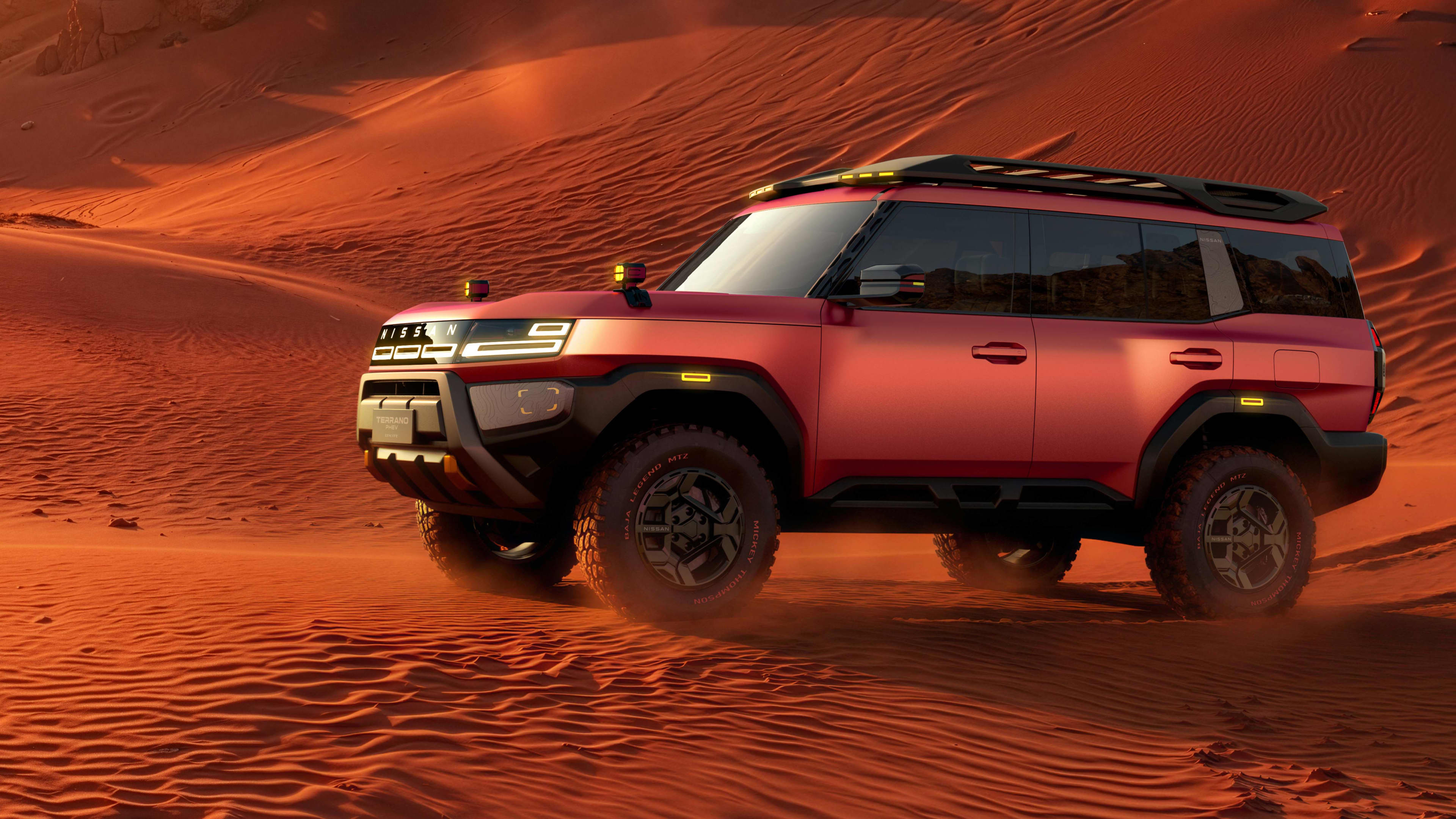 A red Nissan Terran in red sand dunes