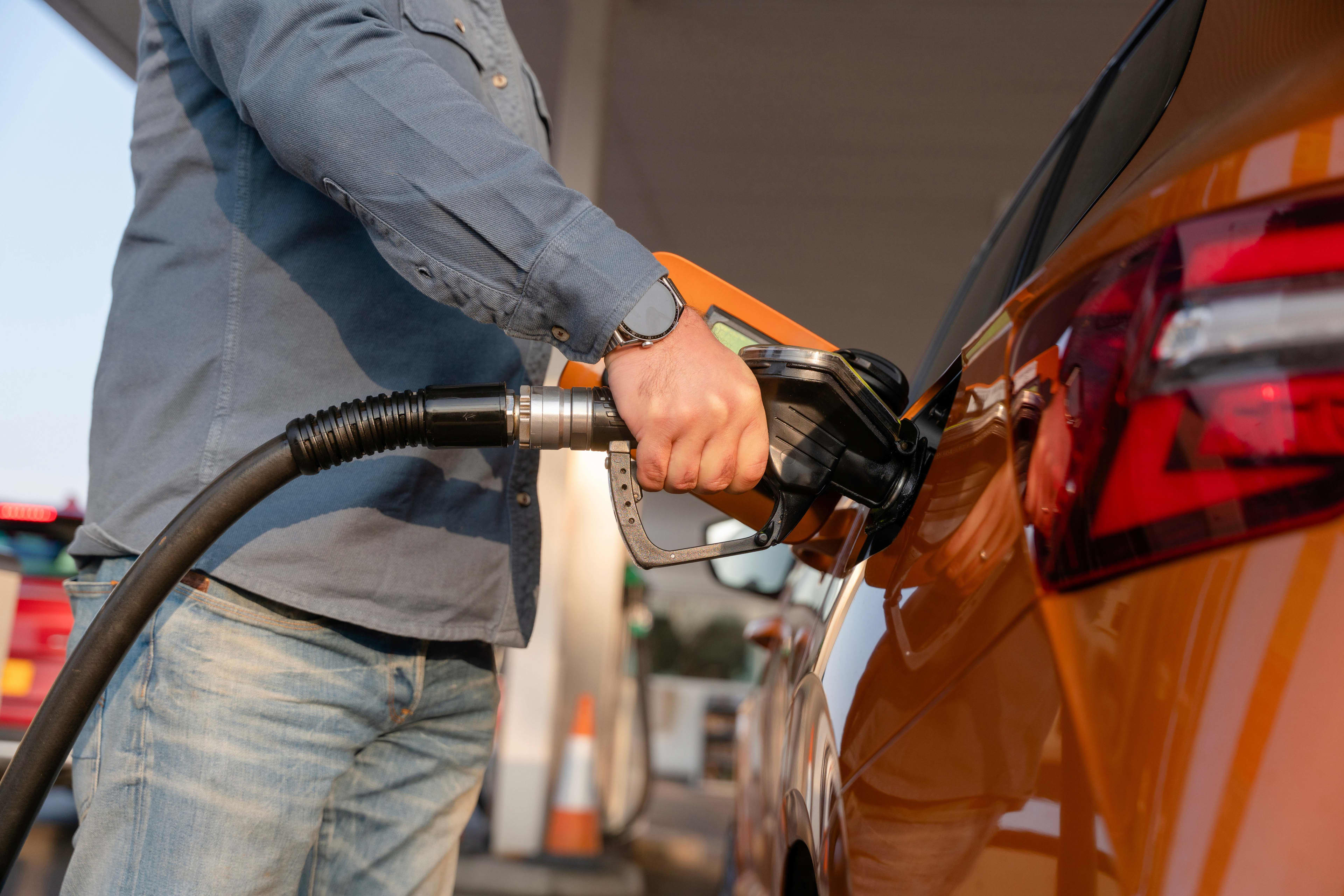 A person filling up a car with fuel