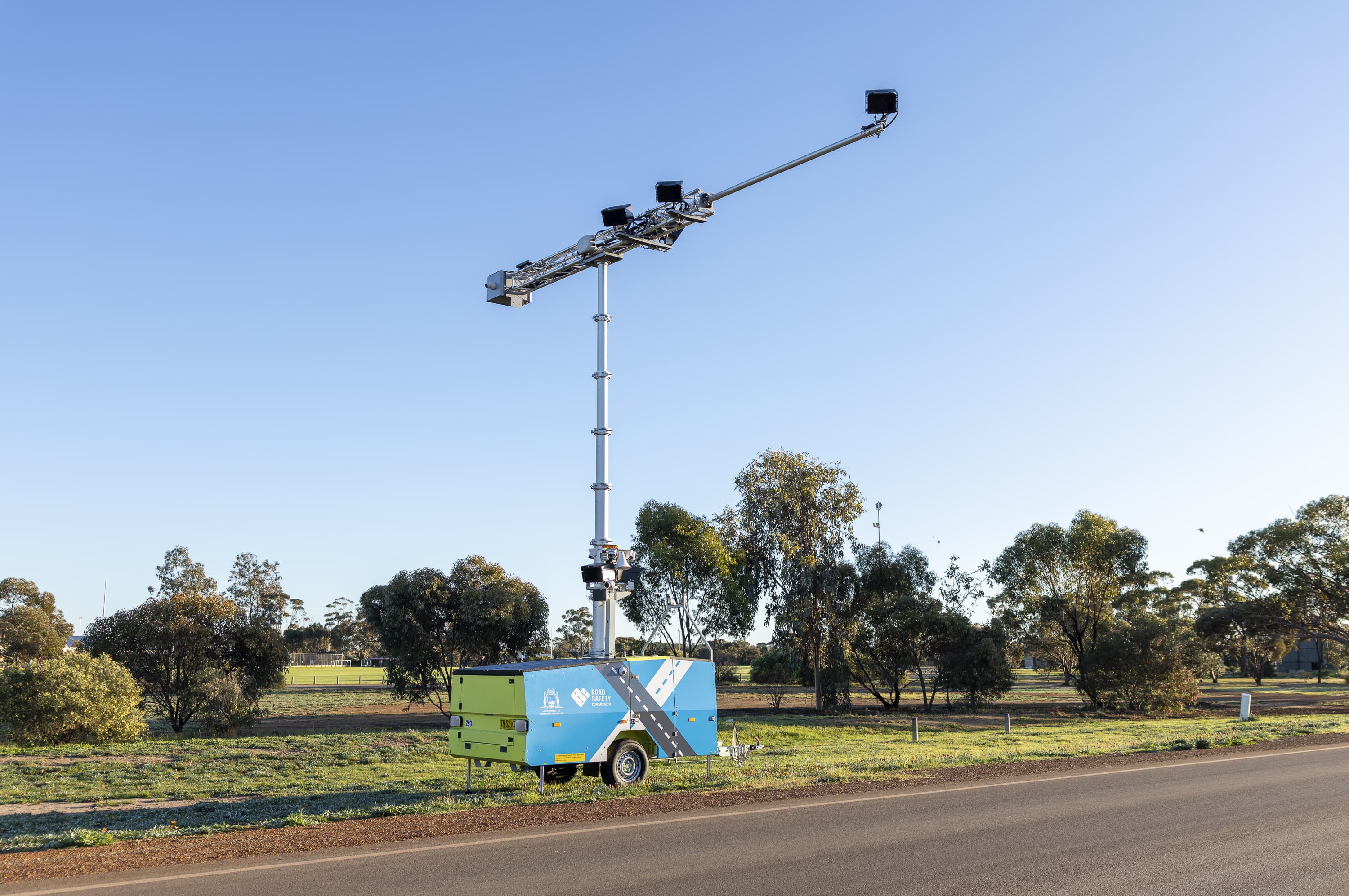 A mobile road safety camera set up on the side of a country road