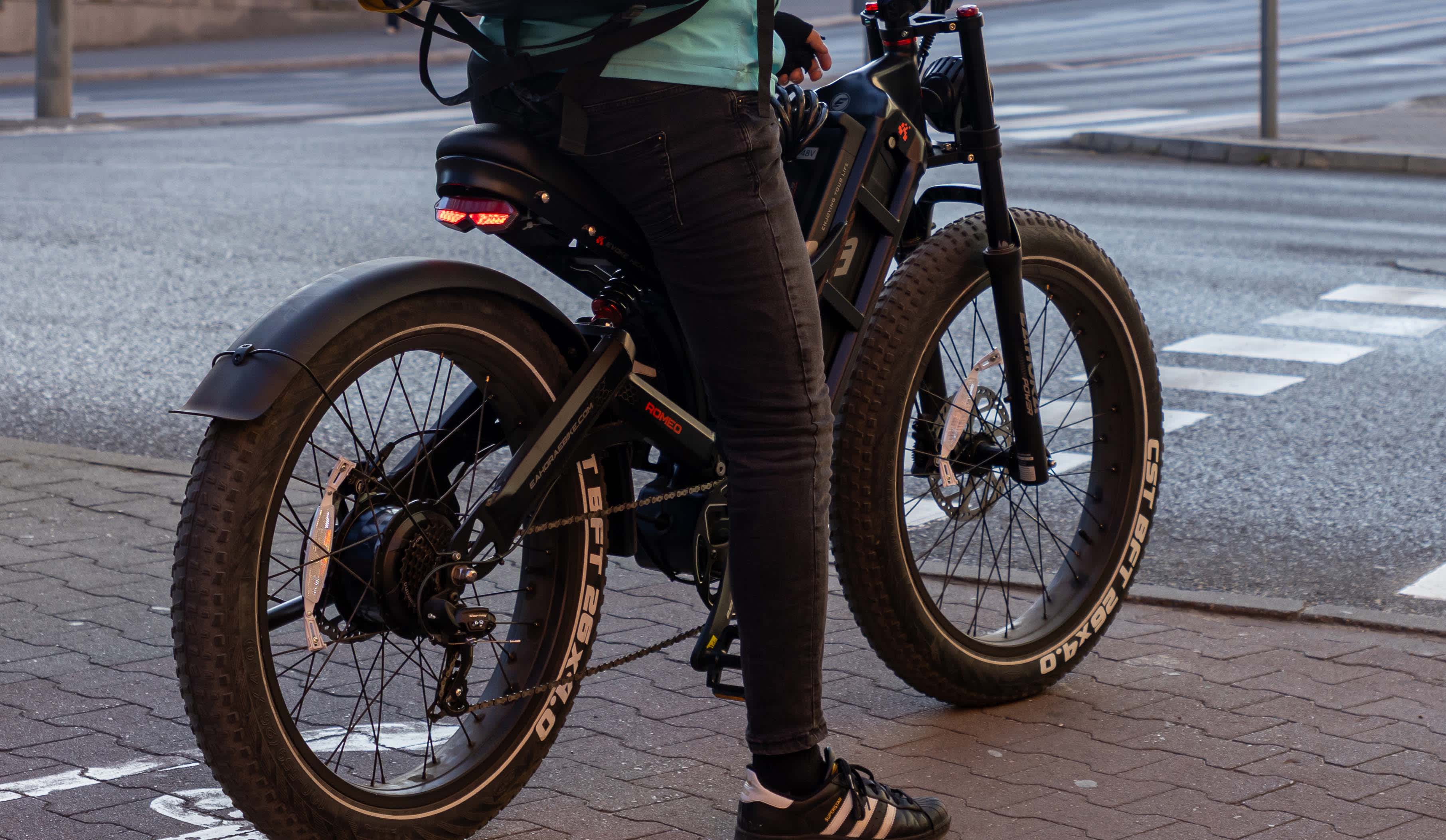 An ebike with extra wide tyres waits by the side of the road