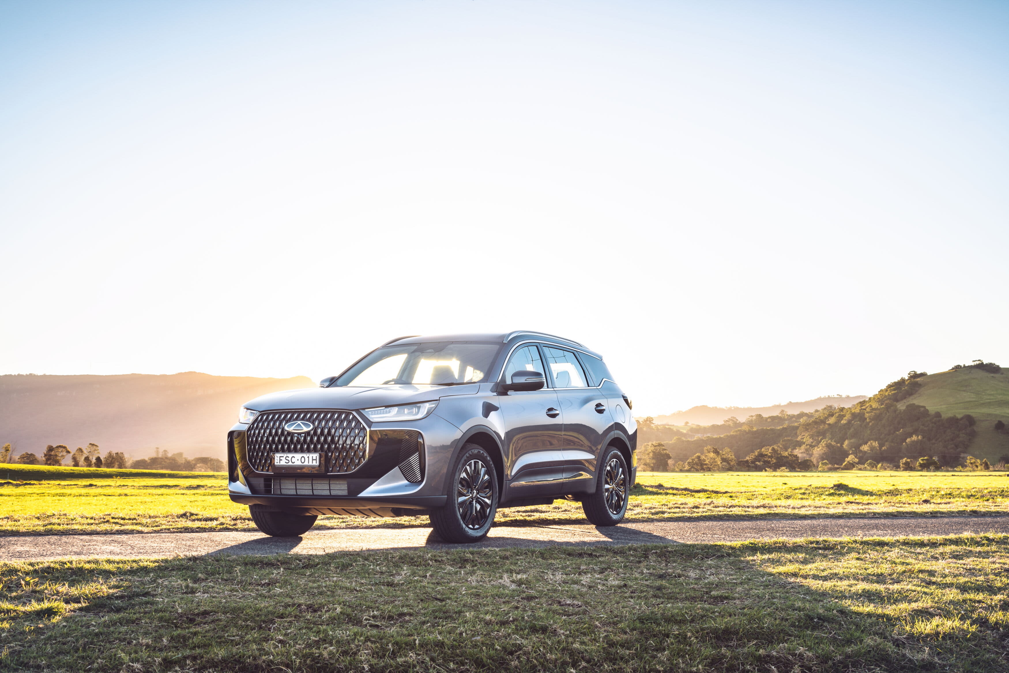 A grey Chery Tiggo 7 SHS parked in a paddock