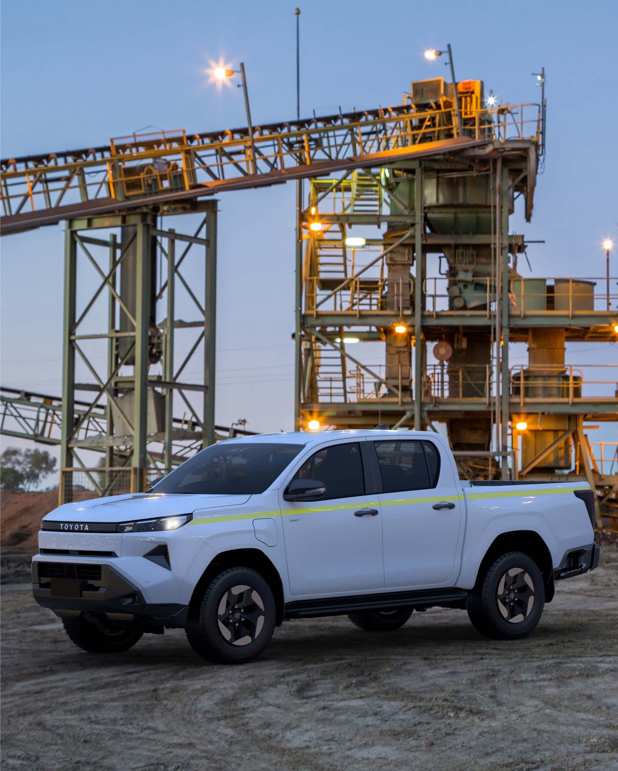 A white Toyota HILUX EV ute in an industrial setting