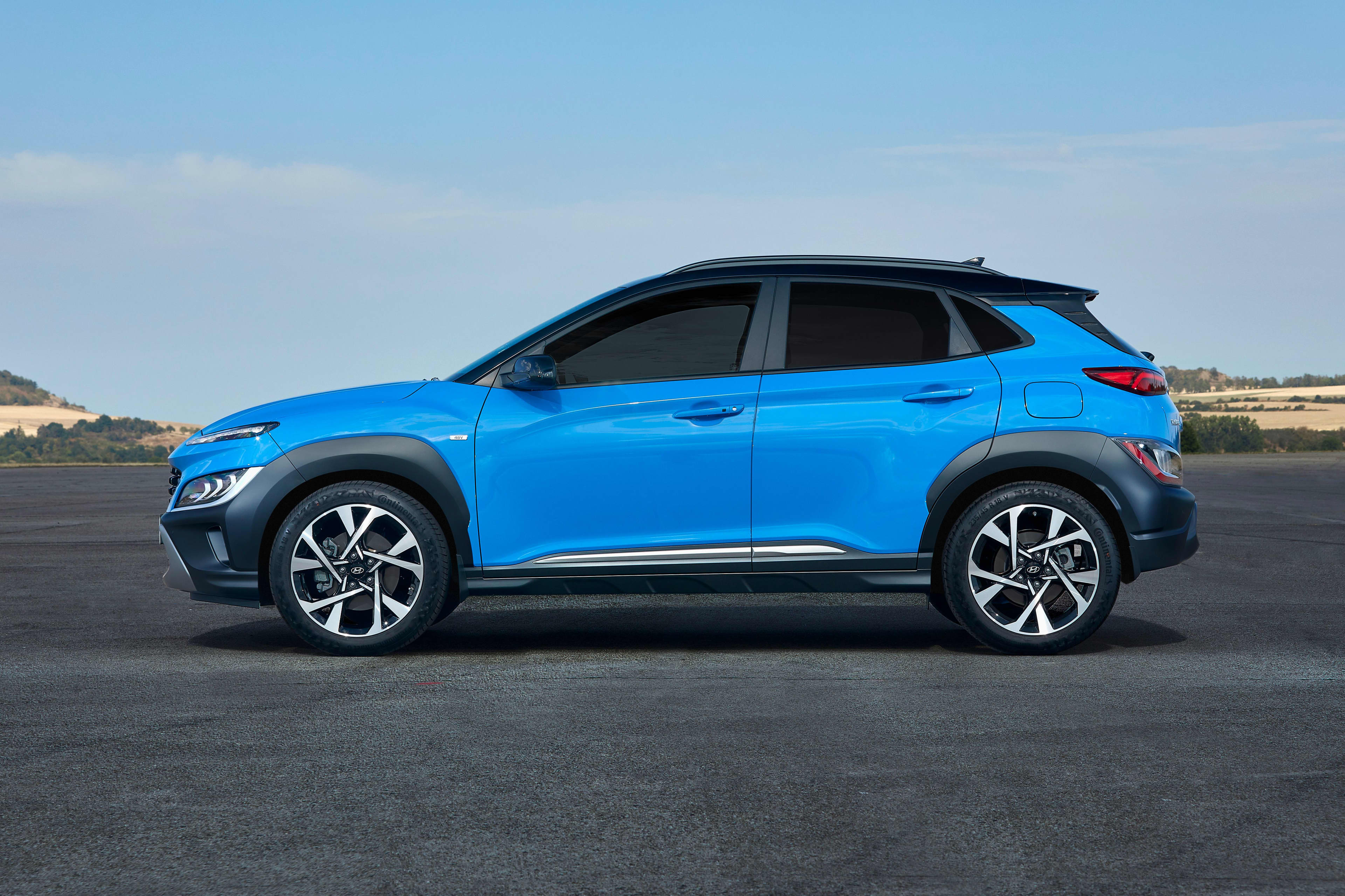 A blue Hyundai Kona parked on tarmac in a regional setting