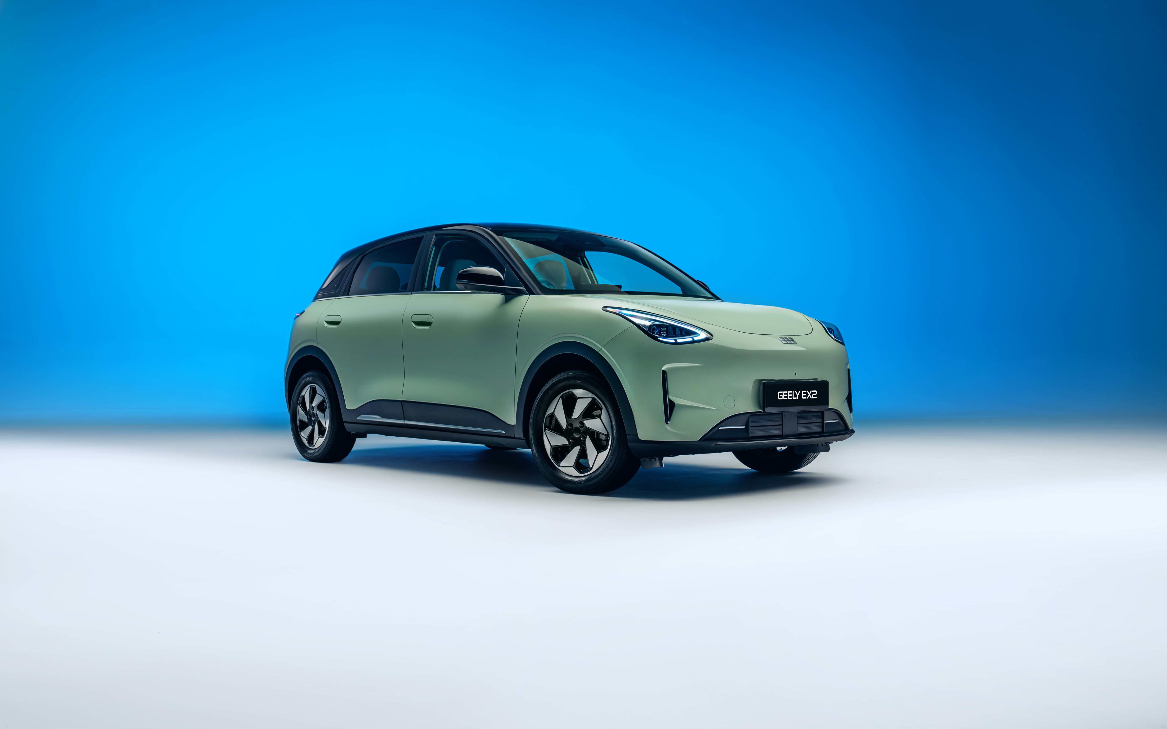 A light green Geely EX2 EV in a studio setting