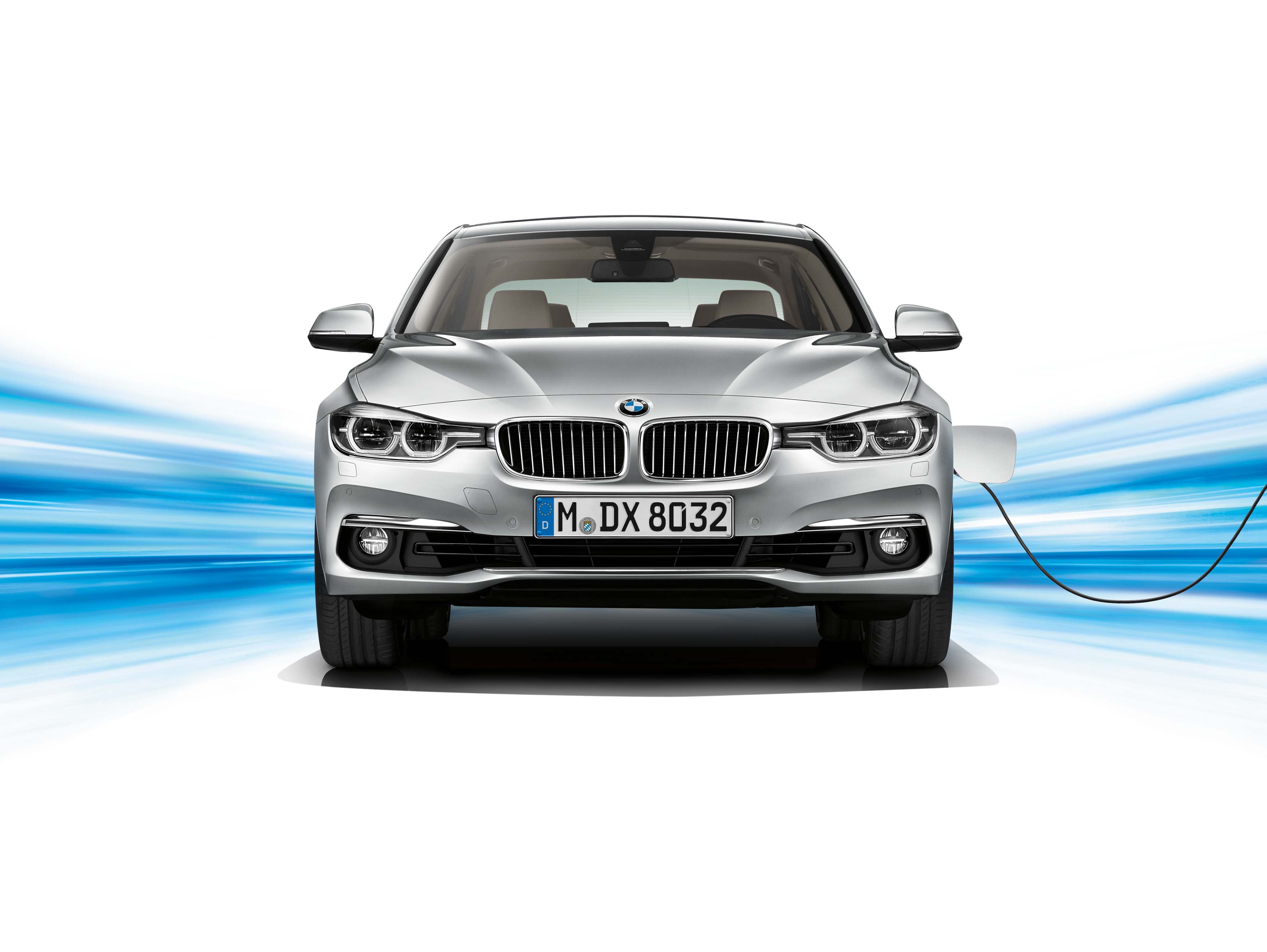 A silver BMW 330e in a studio setting