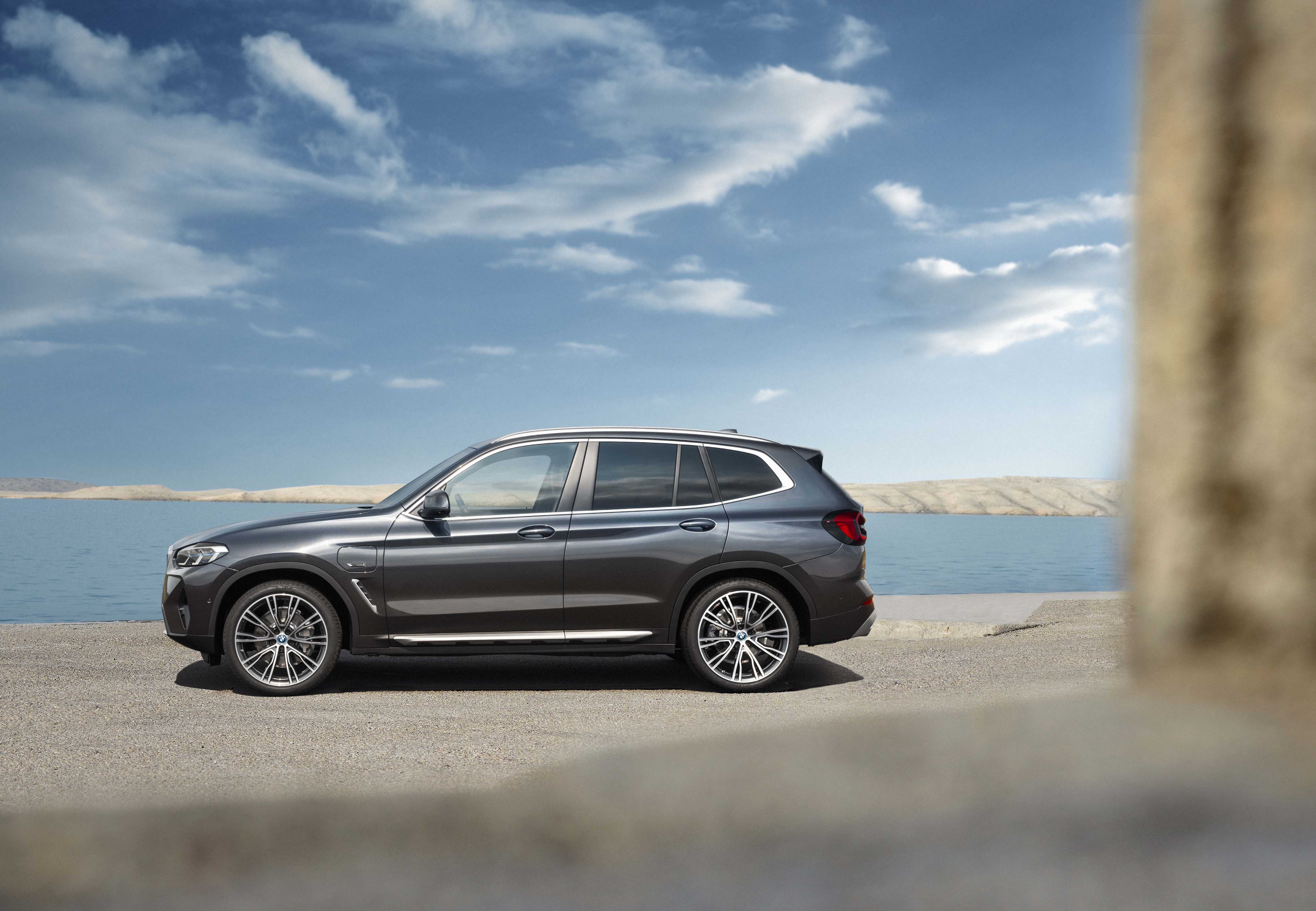 A dark blue BMW X3 parked near a beach