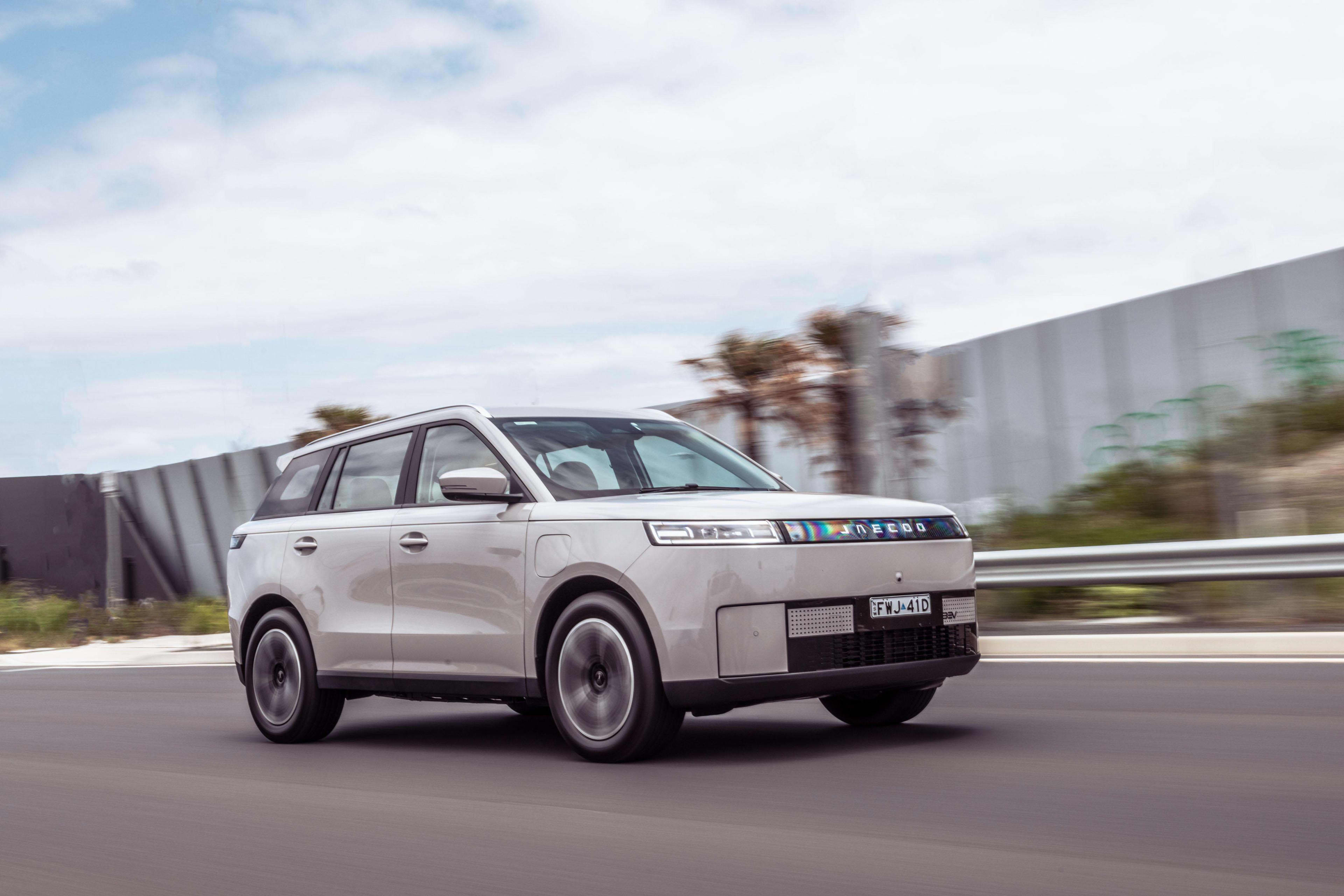 A whiteJjaecoo j5 EV driving on a country road