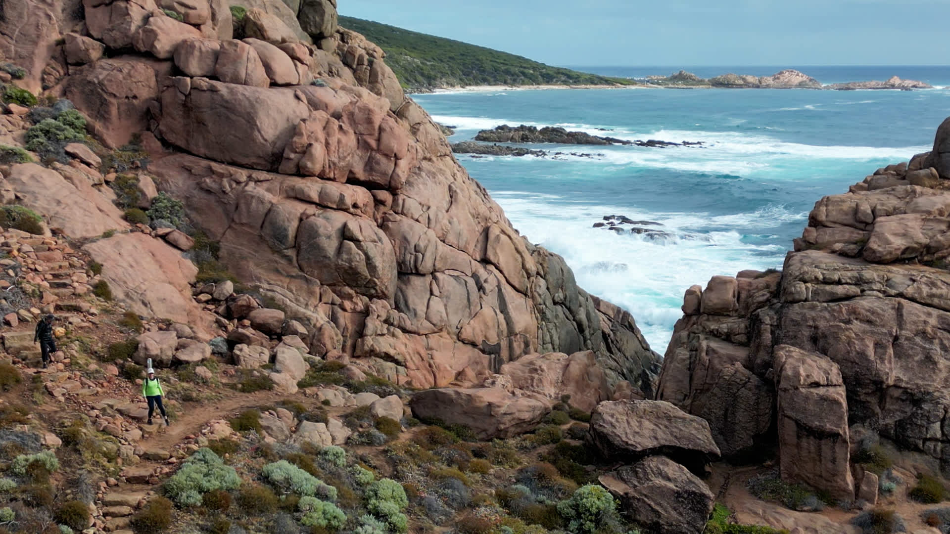 Natural stone steps on the Cape to Cape trail in bushland with ocean as backdrop