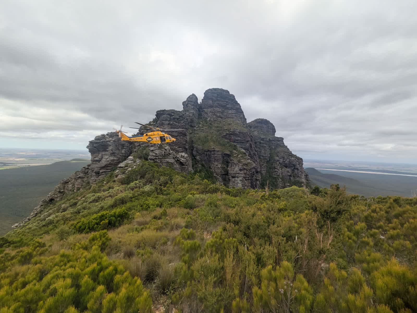 Landscape image of the RAC rescue helicopter next to Bluff Knoll.