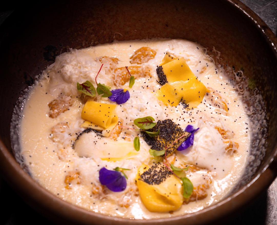 White dish inside bowl adorned with yellow flowers