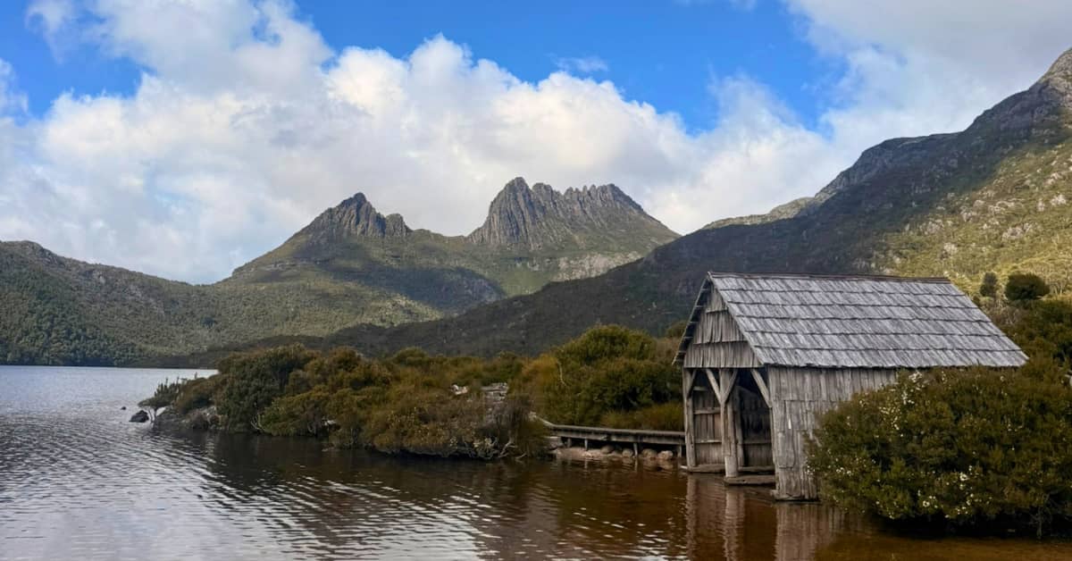 Small boat shed sitting beside lake