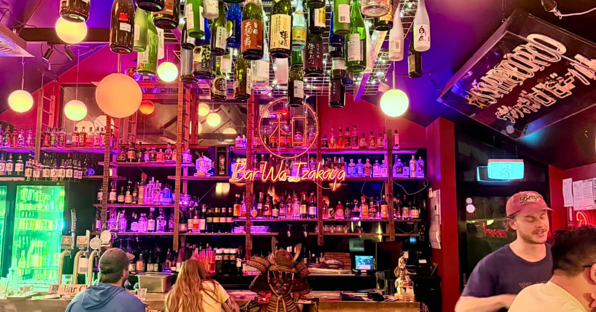 Restaurant with colourful lights and tables of people