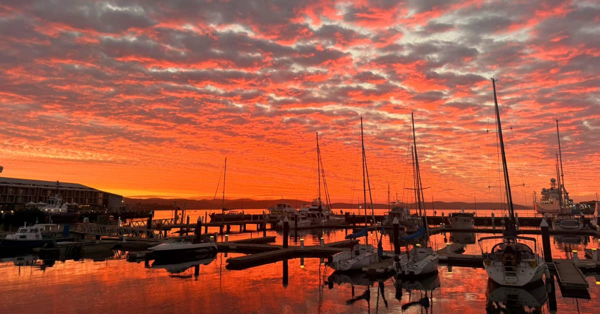 Fiery orange skies over wharf in Hobart