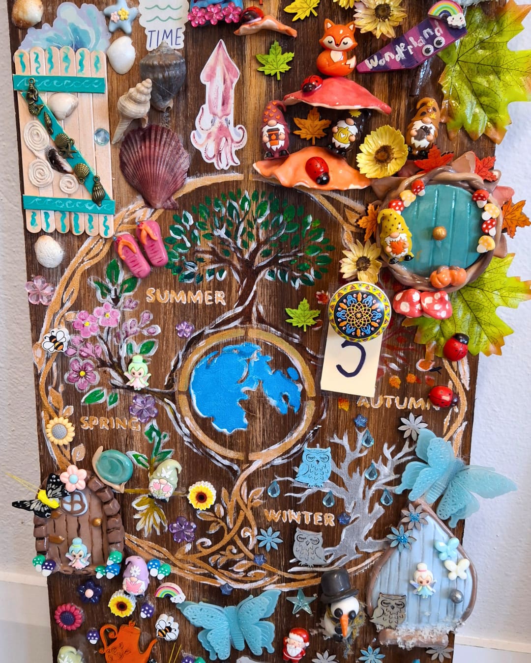 Door adorned and painted with all kinds of colours and trinkets.