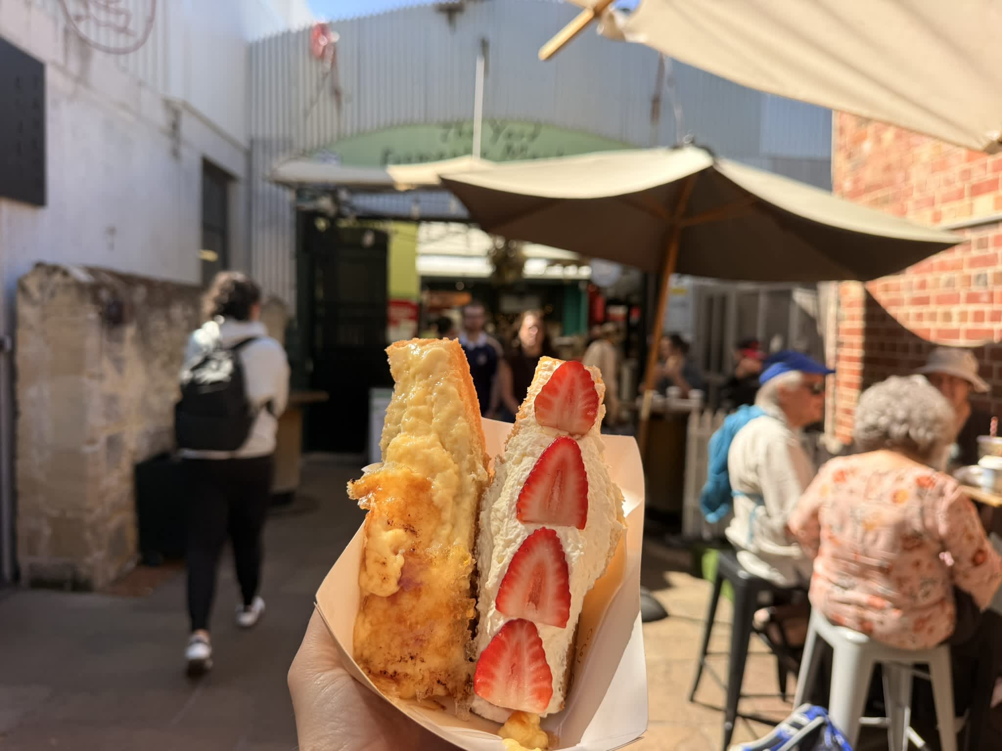 Two servings of loaded french toast with markets in background.