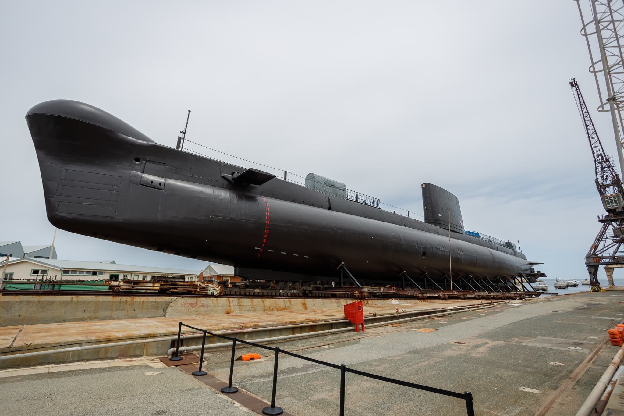Submarine on platform next to ocean.