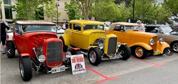 Lineup of classic cars at event.