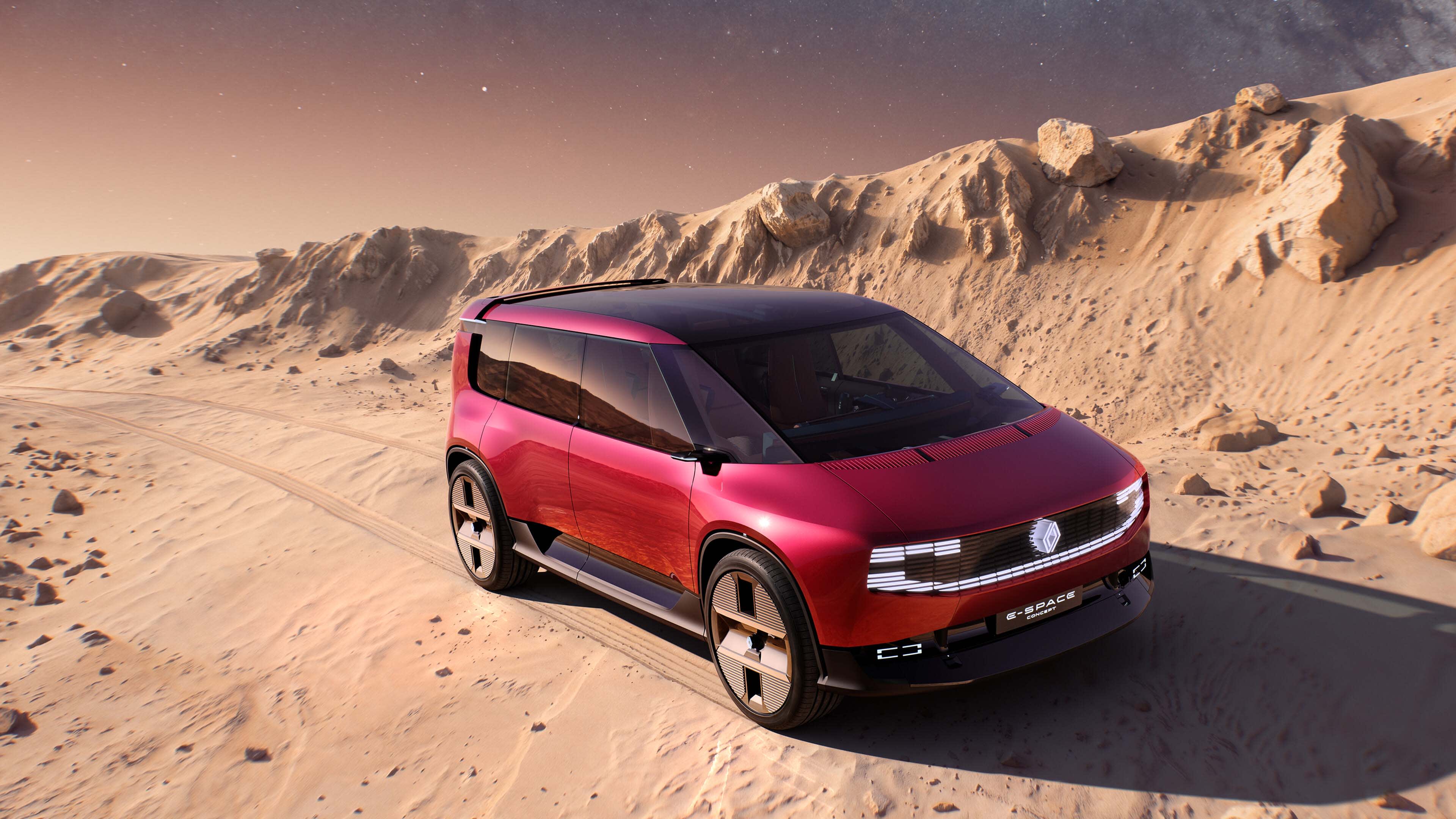 A red multi-purpose vehicle driving along a moon-like landscape.