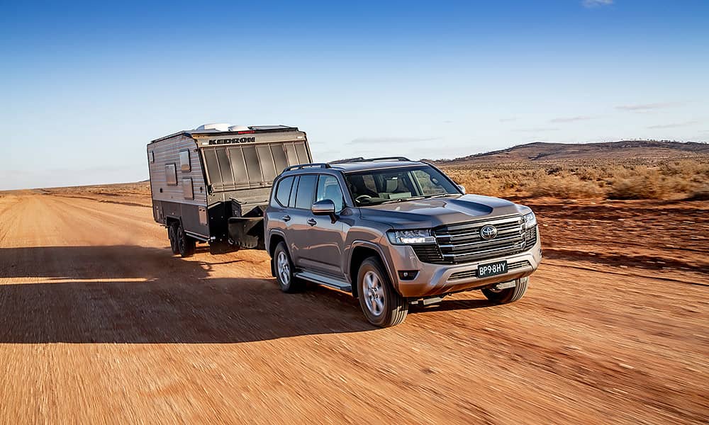 A Toyota Landcruiser 300 series towing a caravan