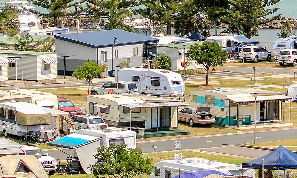 Caravans and tents near water