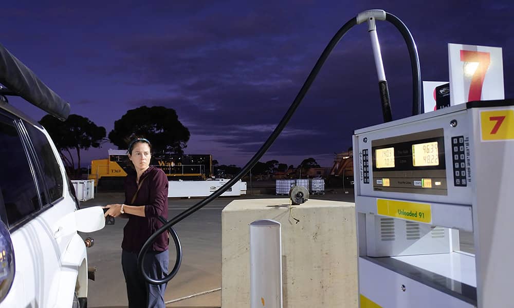 A woman filling her car with petrol
