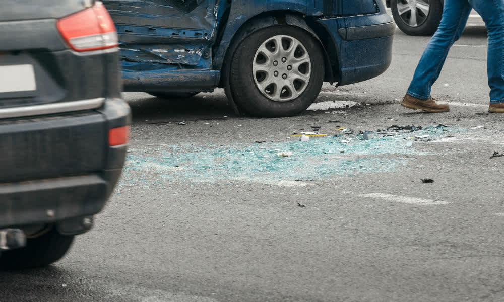 A car crash with broken glass on the floor