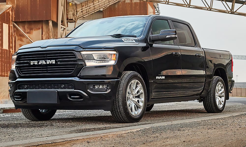 A black Ram Silverado on the road in an industrial area