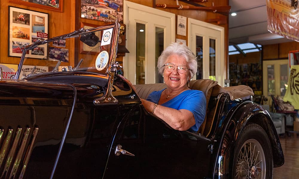 Mary Ann posing with her 1947 MG TC inside her garage